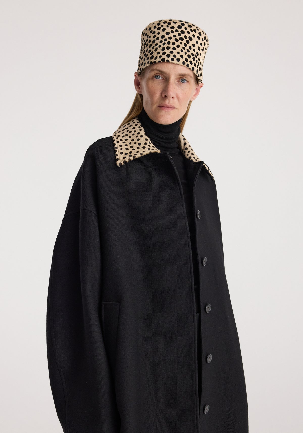 Cheetah collar wool coat | black modeled with a distinctive cheetah print collar and matching hat, button front, and relaxed silhouette