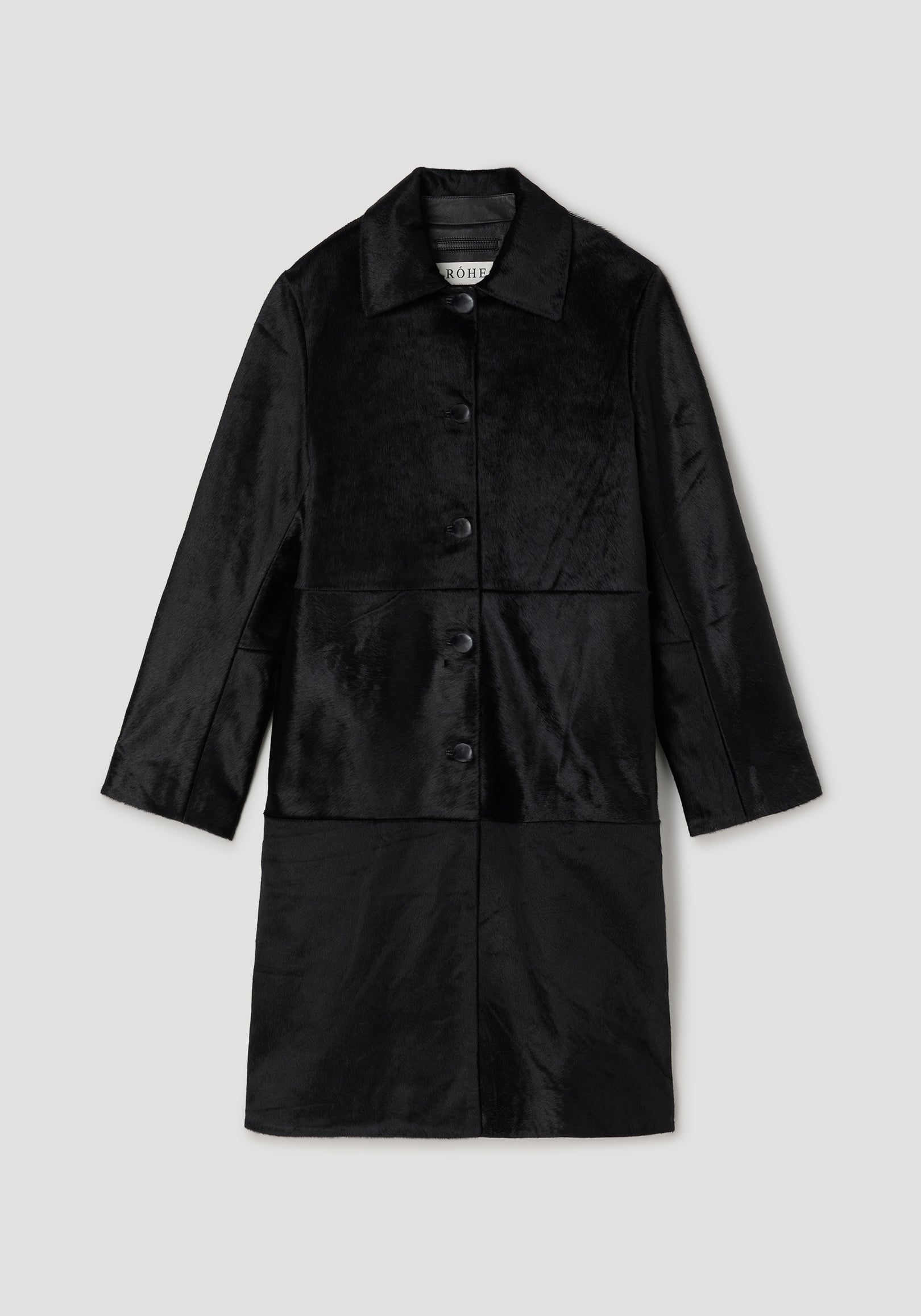 Black ponyhair coat | black with a classic collar, long sleeves, and button closure, featuring a soft textured finish and a sleek, elegant design.