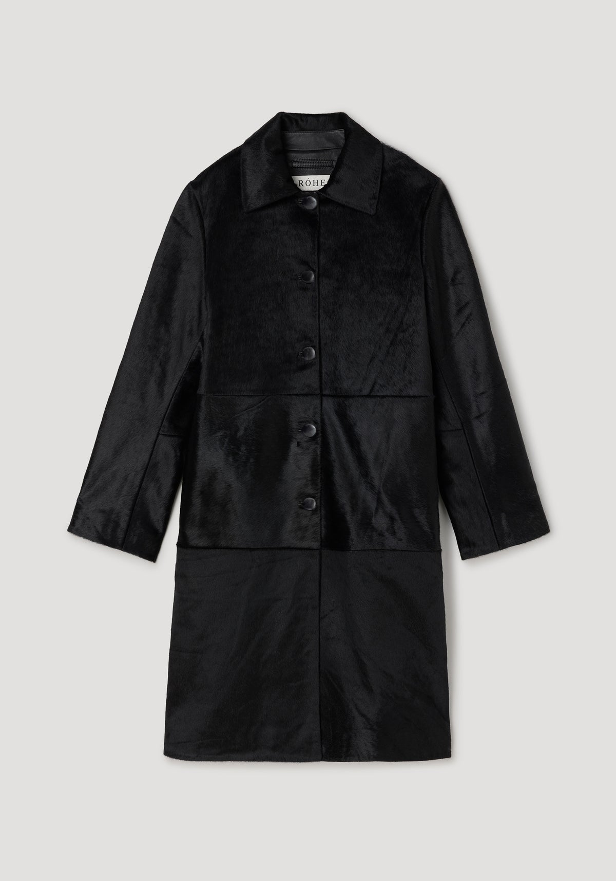 Black ponyhair coat | black with a classic collar, long sleeves, and button closure, featuring a soft textured finish and a sleek, elegant design.