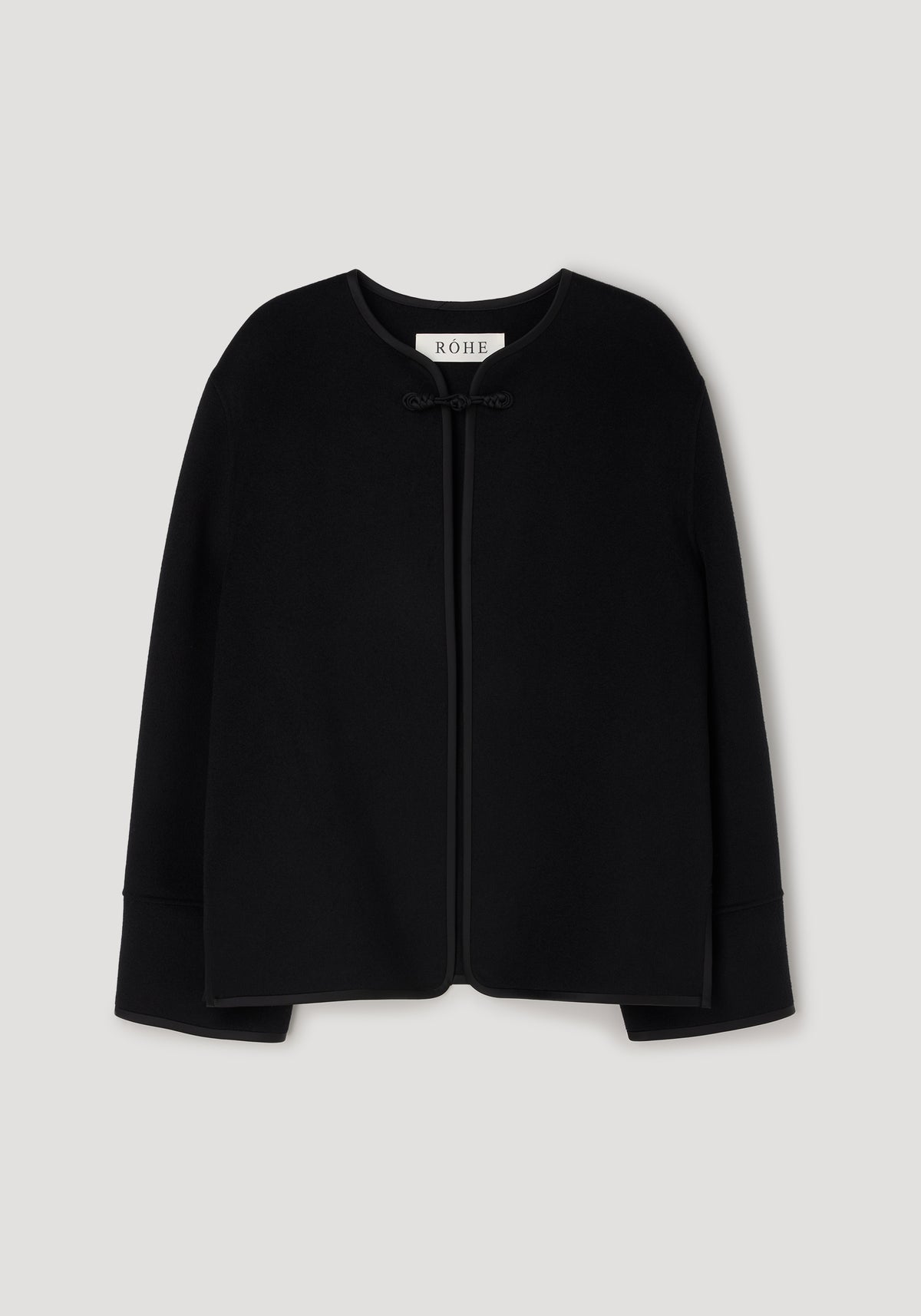 Black minimalistic jacket with a round neckline and a pankou knot closure at the front, featuring the design details of the Double-faced pankou jacket | black.