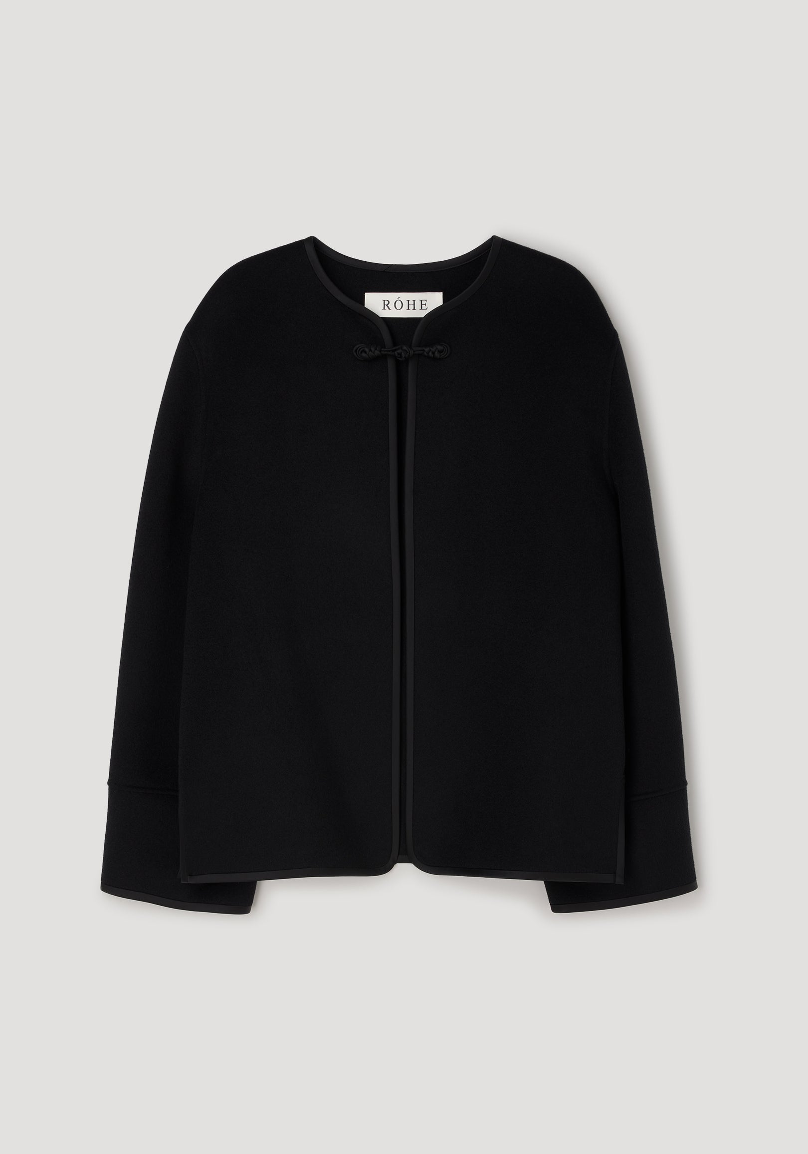 Black minimalistic jacket with a round neckline and a pankou knot closure at the front, featuring the design details of the Double-faced pankou jacket | black.