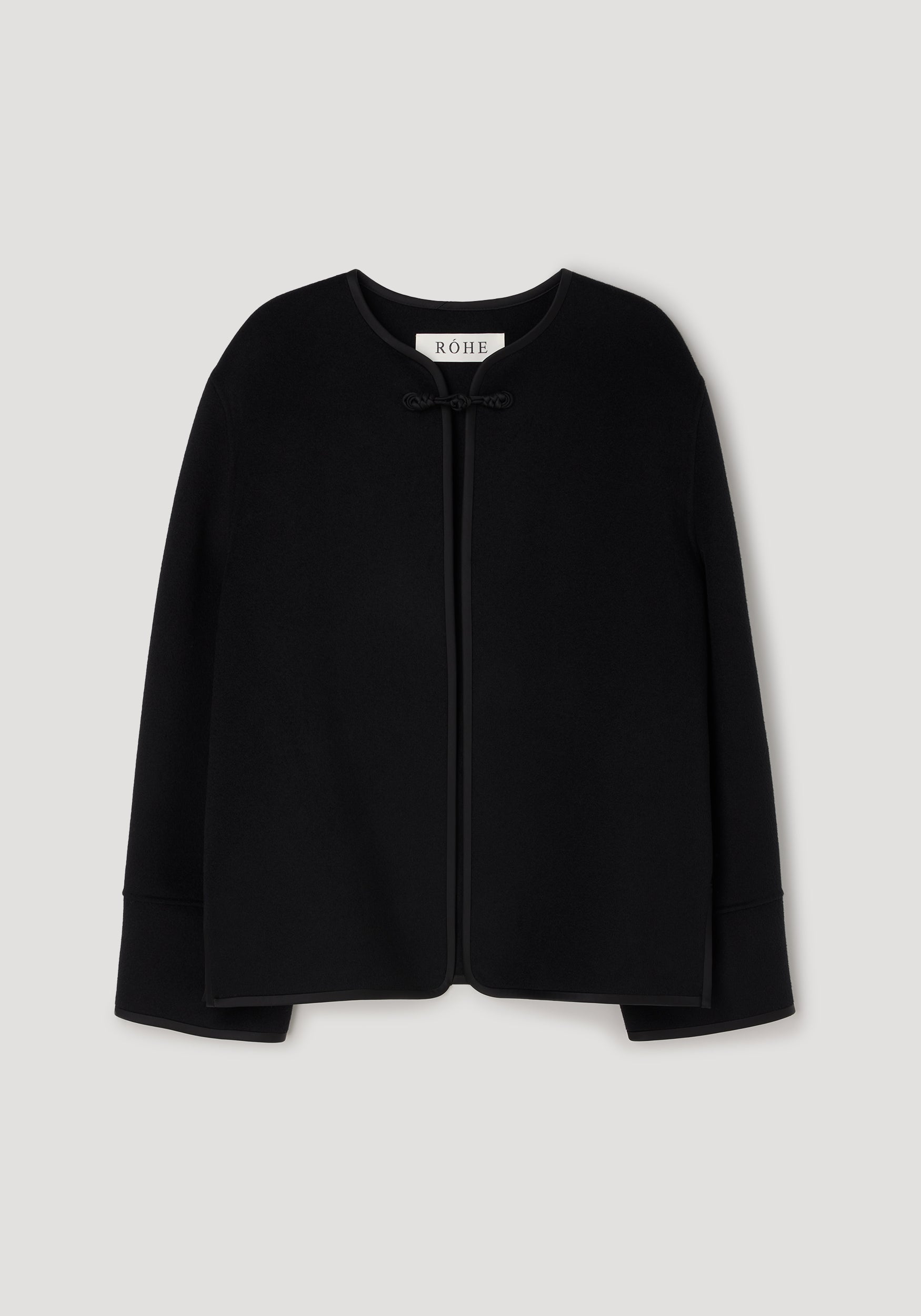 Black minimalistic jacket with a round neckline and a pankou knot closure at the front, featuring the design details of the Double-faced pankou jacket | black.