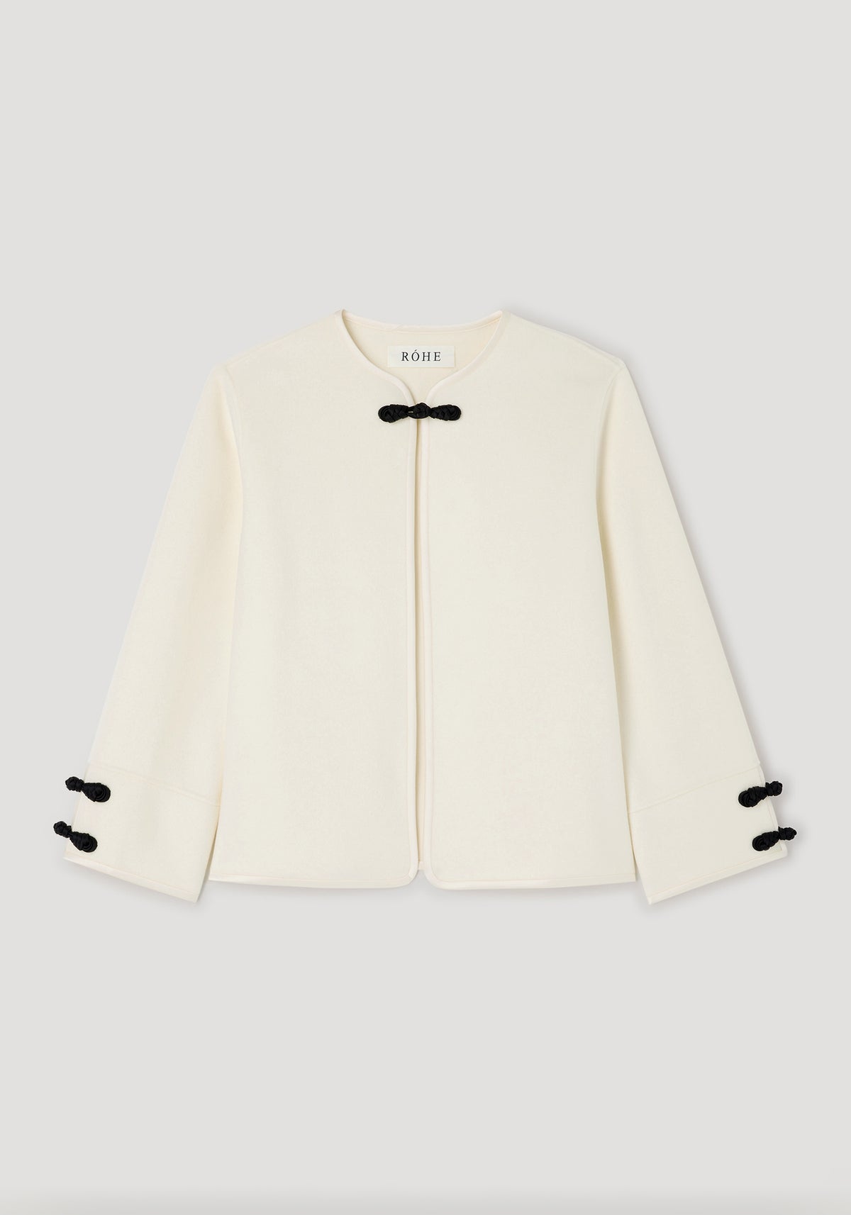 Double-faced pankou jacket | off white shown flat, featuring a minimalist design with black pankou knot fastenings at the neck and cuffs on a light background.