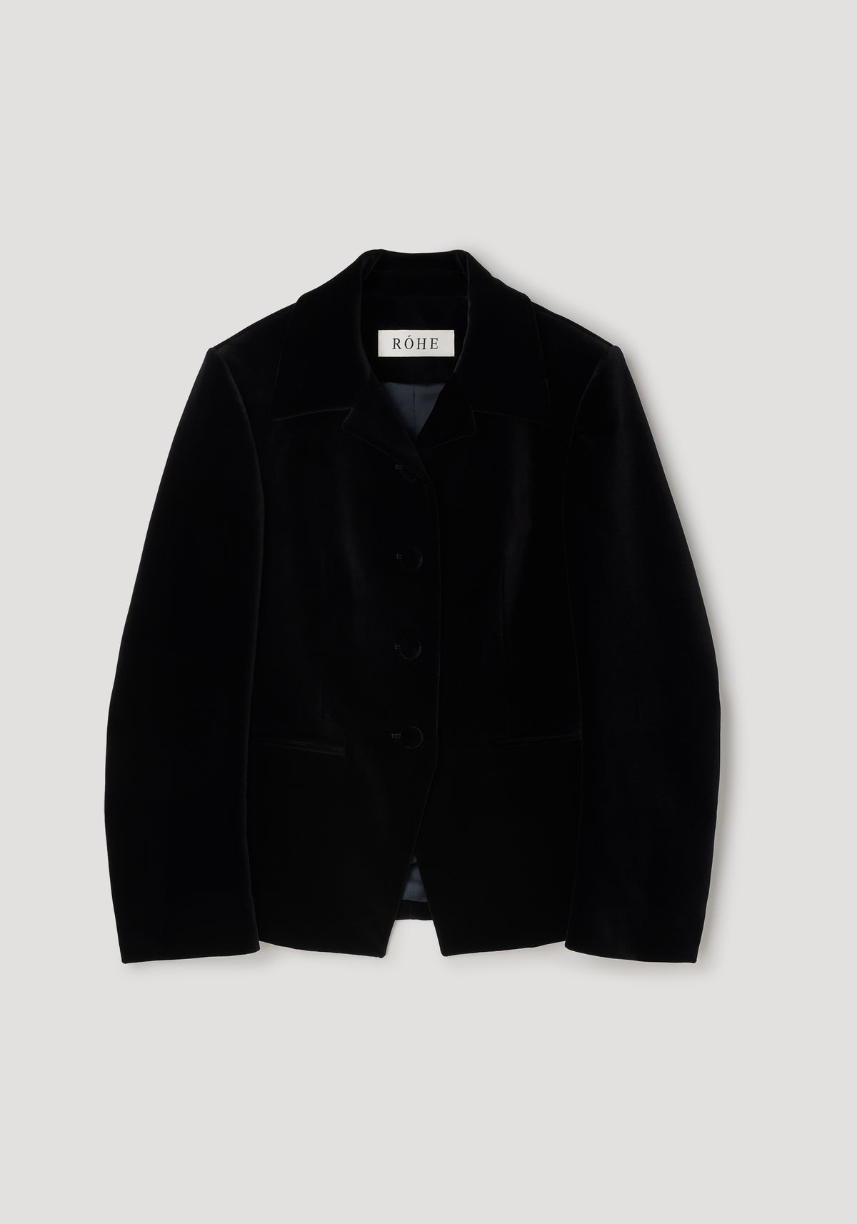 Classic fitted velvet blazer | black displayed flat, showing its tailored design with a notch lapel collar and three-button front closure.