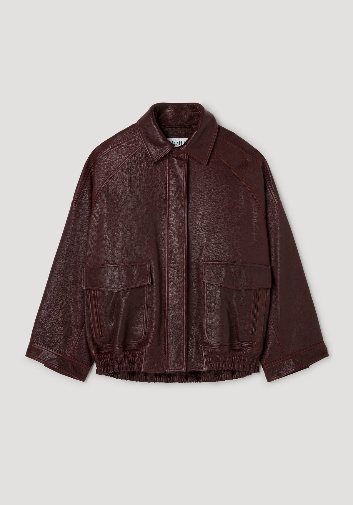 Grain leather aviator jacket | chestnut shown against a plain light background with zip front, pointed collar, flap pockets, and ribbed hem and cuffs