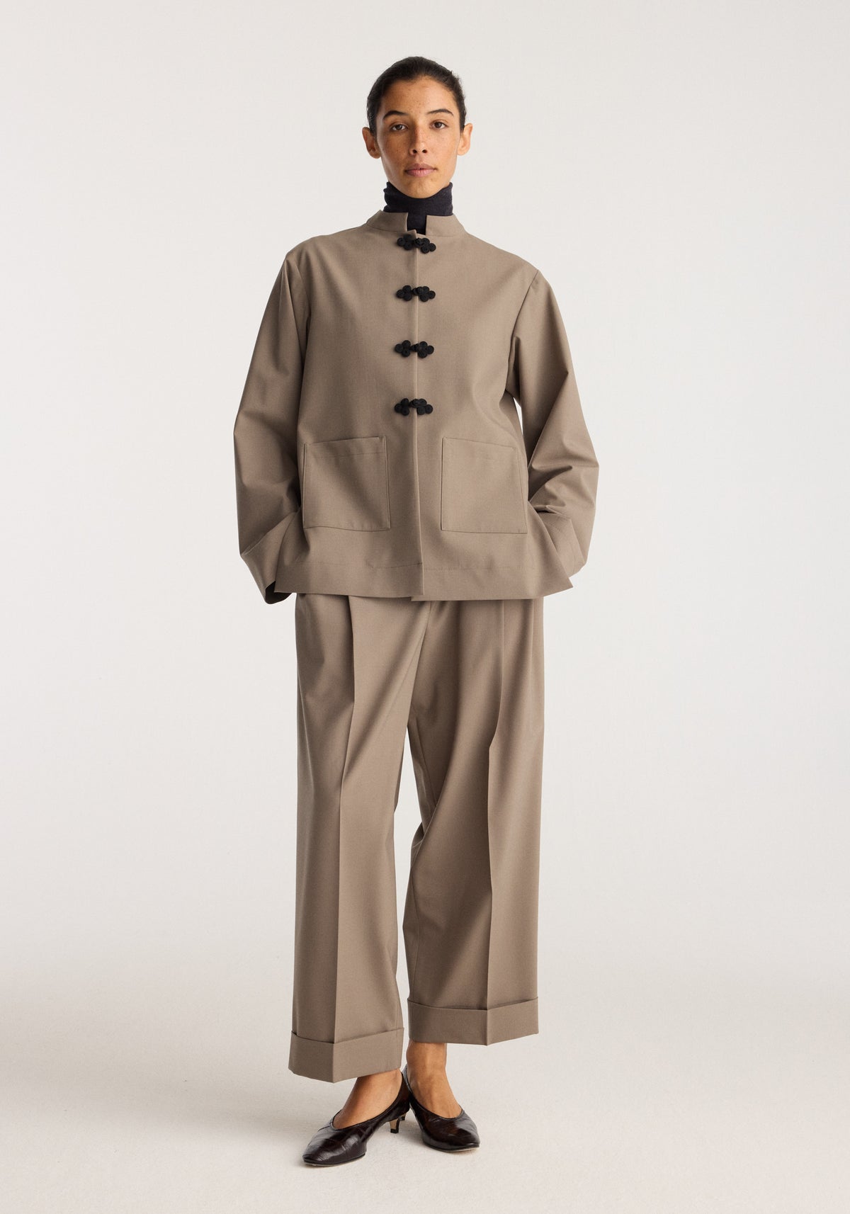 Pankou closure jacket | taupe worn with matching cropped trousers and black flats in a studio setting