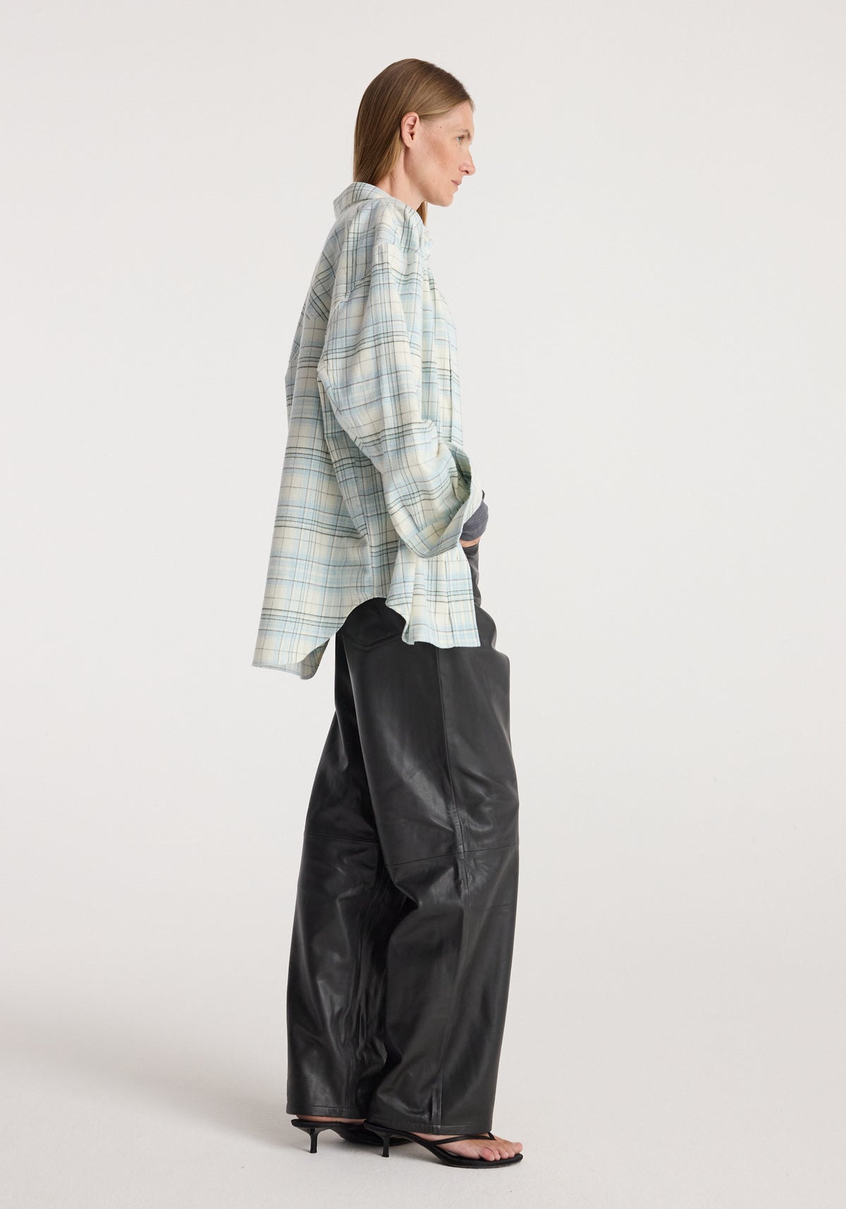 Flannel check overshirt | sea green check, shown from the side on a model styled with black trousers and sandals against a neutral studio background