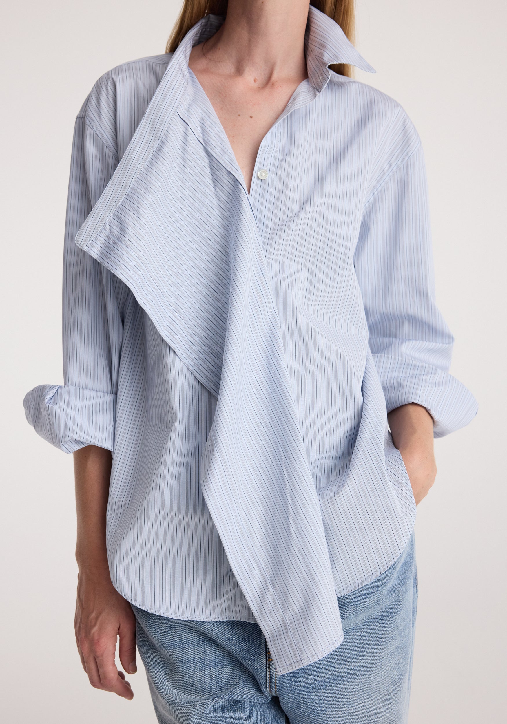 Draped collar shirt | blue stripe worn with rolled sleeves and light wash jeans, featuring a flowing layered front and relaxed fit