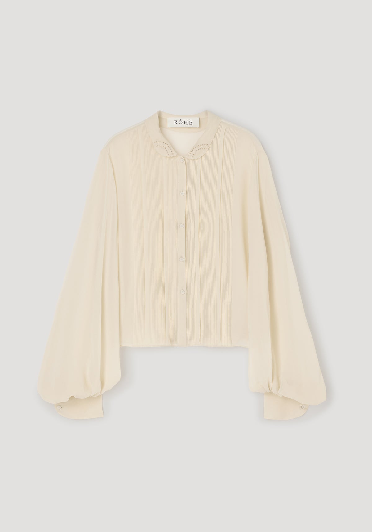 Romantic top | cream with long puffed sleeves, delicate button-down front, and a soft rounded collar featuring subtle cutout details, showcasing a light and elegant design.