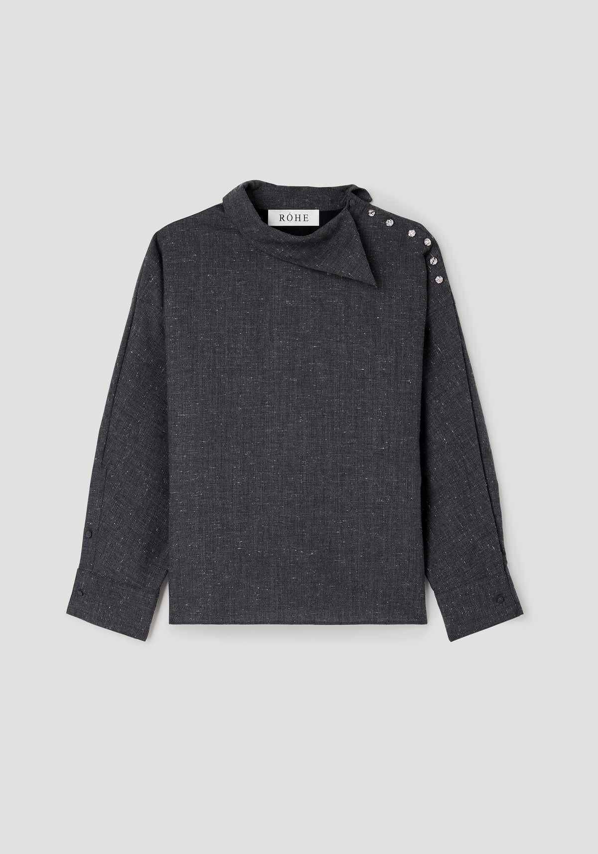 Reimagined collar top | grey slub in dark grey fabric with a textured slub pattern, featuring long sleeves, an asymmetrical collar, and decorative buttons on one shoulder.