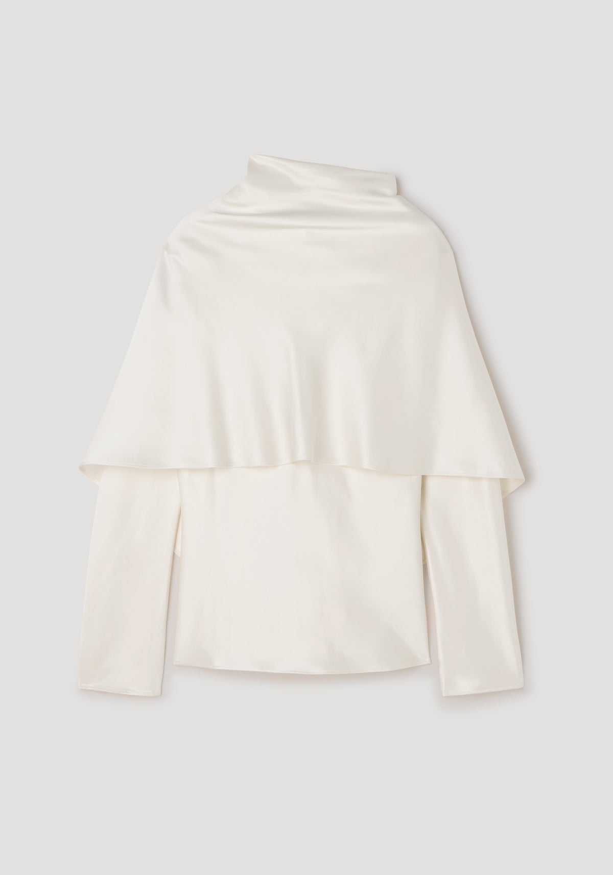 Satin cape top | cream displayed flat, featuring a smooth, shiny satin fabric with a cape overlay draped over long sleeves and a high neckline.