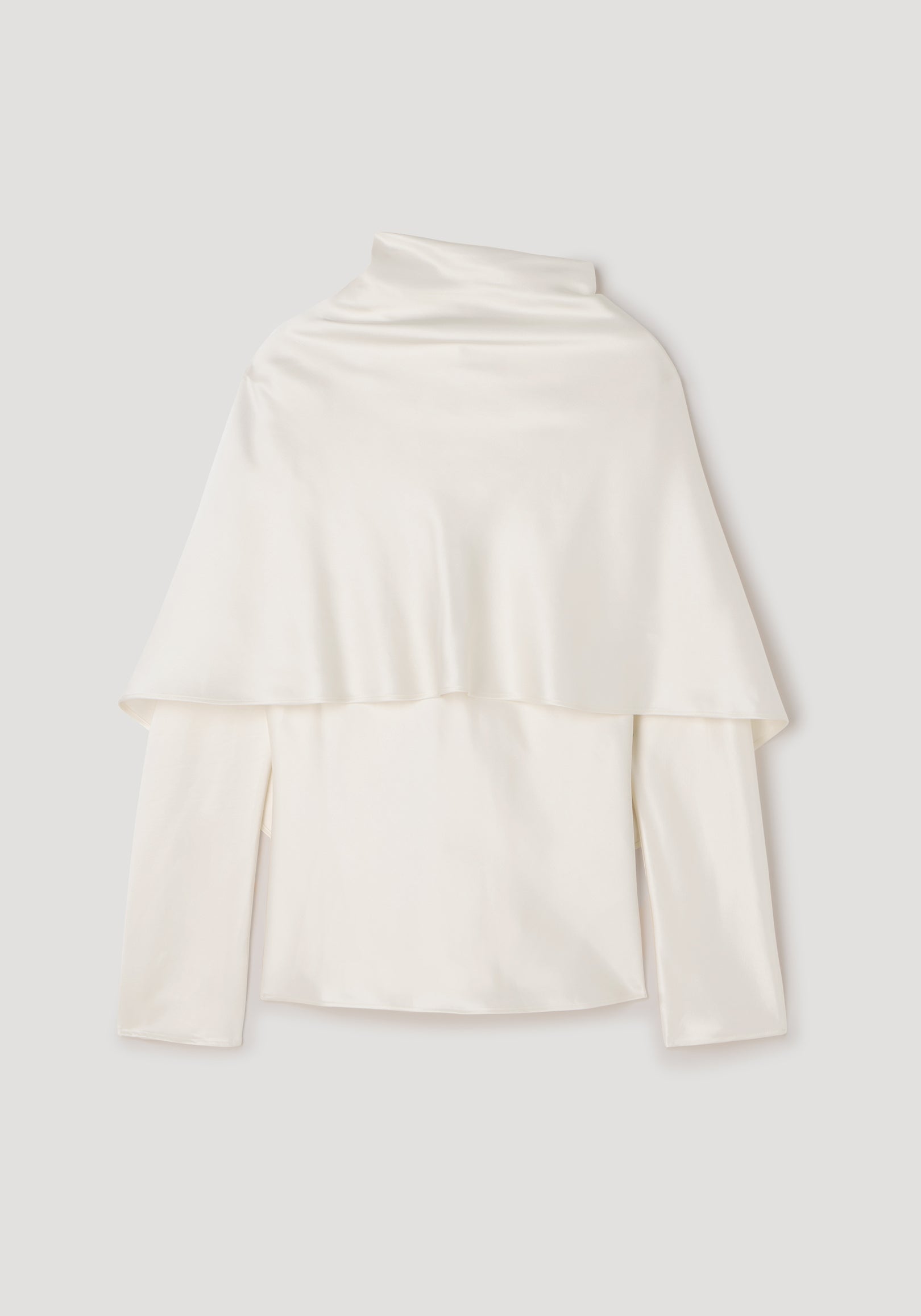 Satin cape top | cream displayed flat, featuring a smooth, shiny satin fabric with a cape overlay draped over long sleeves and a high neckline.