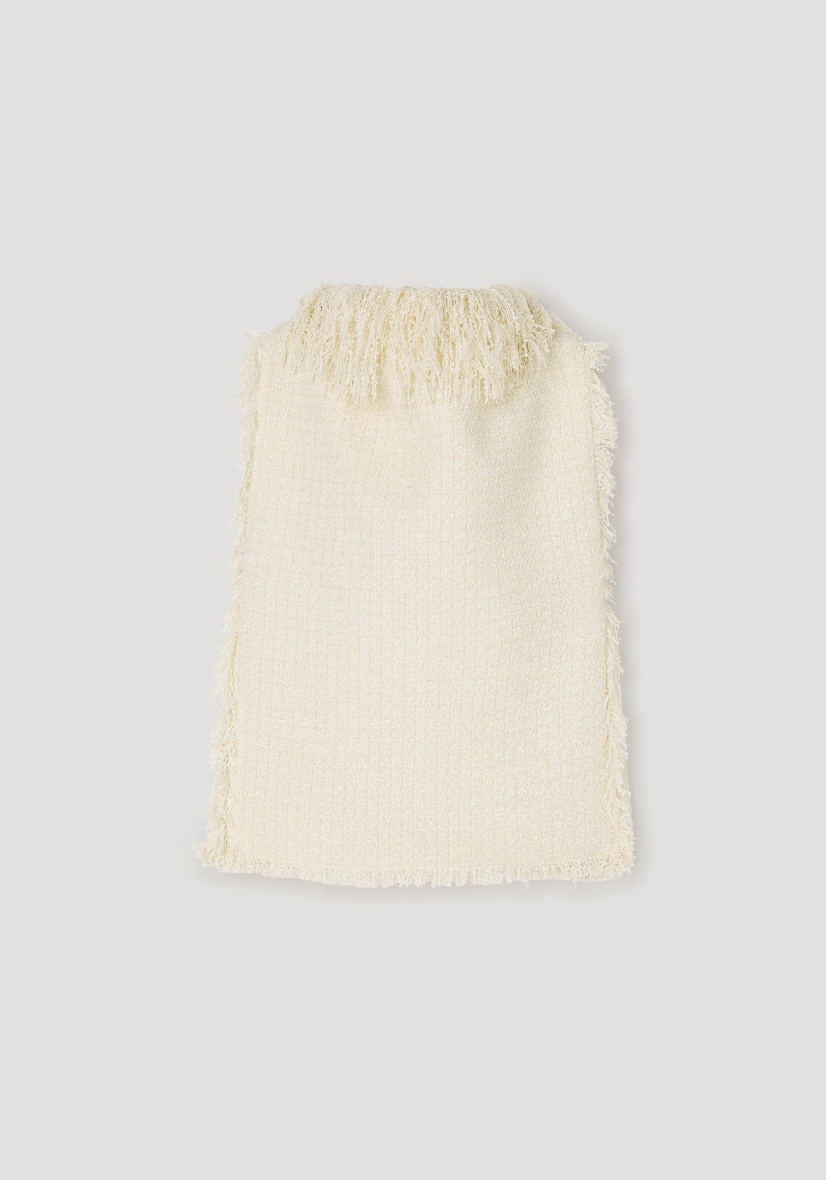 Cream textured fringe bouclé top | cream with soft fringed detailing along the neckline and edges, showcasing a cozy and stylish woven fabric design.