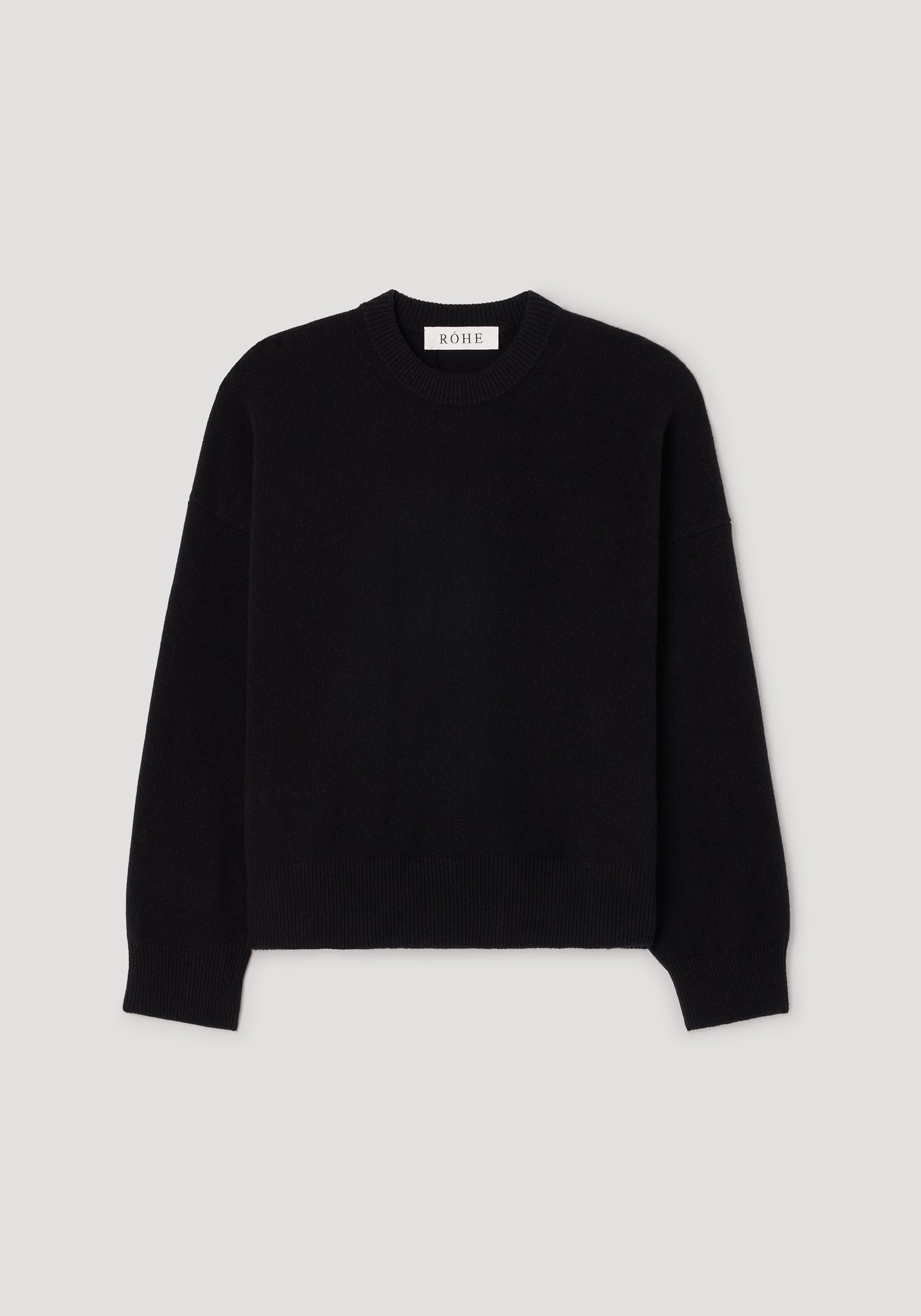 Classic crewneck jumper | black displayed on a plain background, featuring long sleeves and a ribbed neckline, cuffs, and hem for a simple yet timeless look.