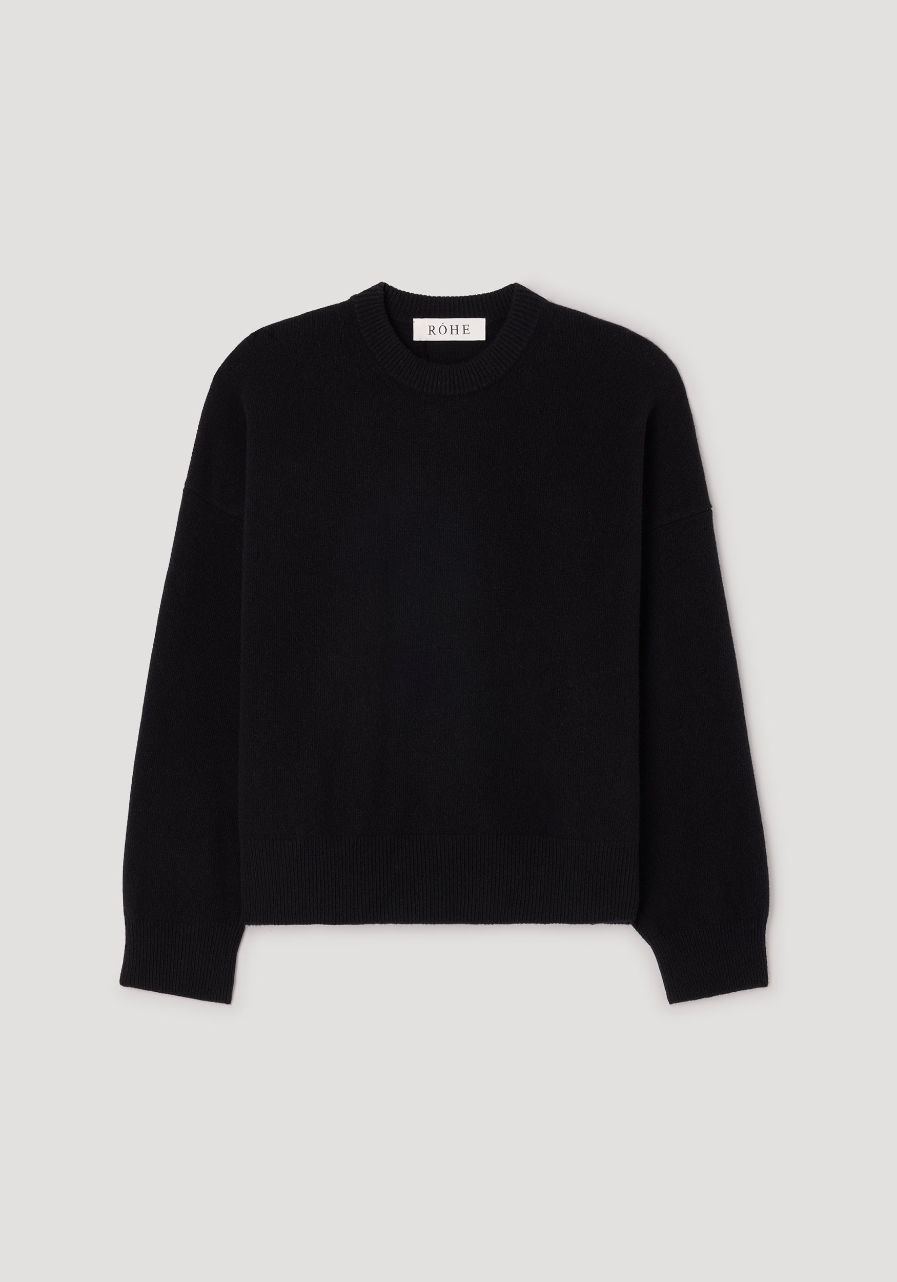 Classic crewneck jumper | black displayed on a plain background, featuring long sleeves and a ribbed neckline, cuffs, and hem for a simple yet timeless look.