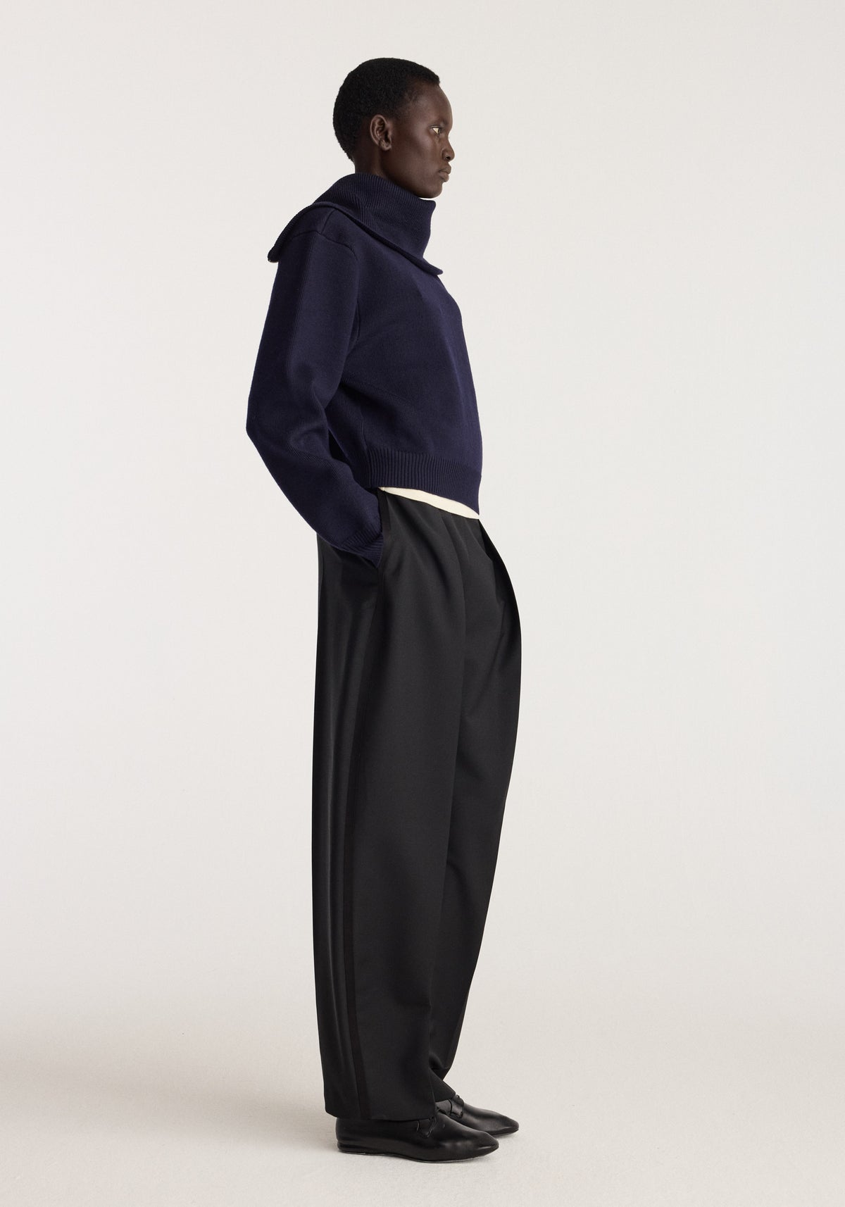 Reversible sailor zip cardigan | navy shown on a model in side profile with a high collar and relaxed fit, styled with black trousers and shoes