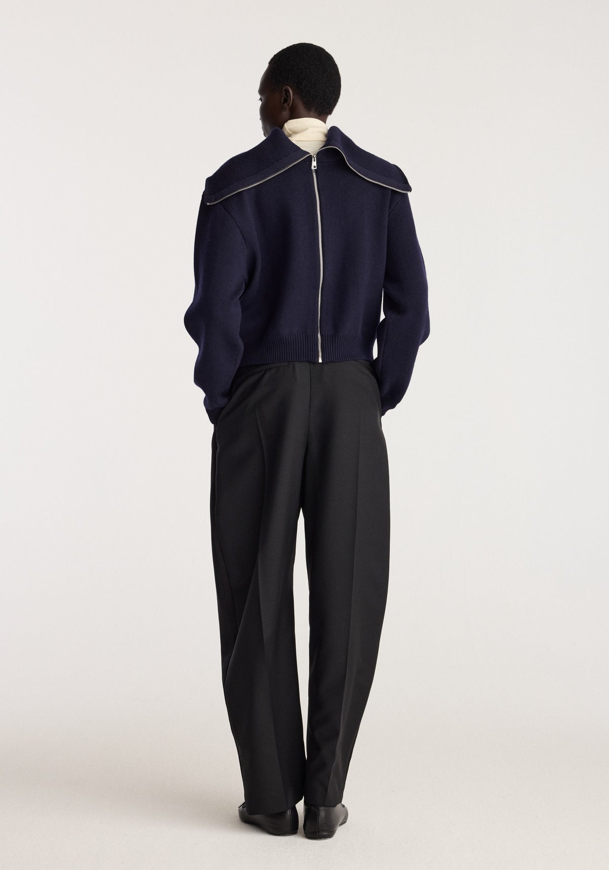 Reversible sailor zip cardigan | navy shown from the back on a model with a sailor collar and zip front paired with black trousers
