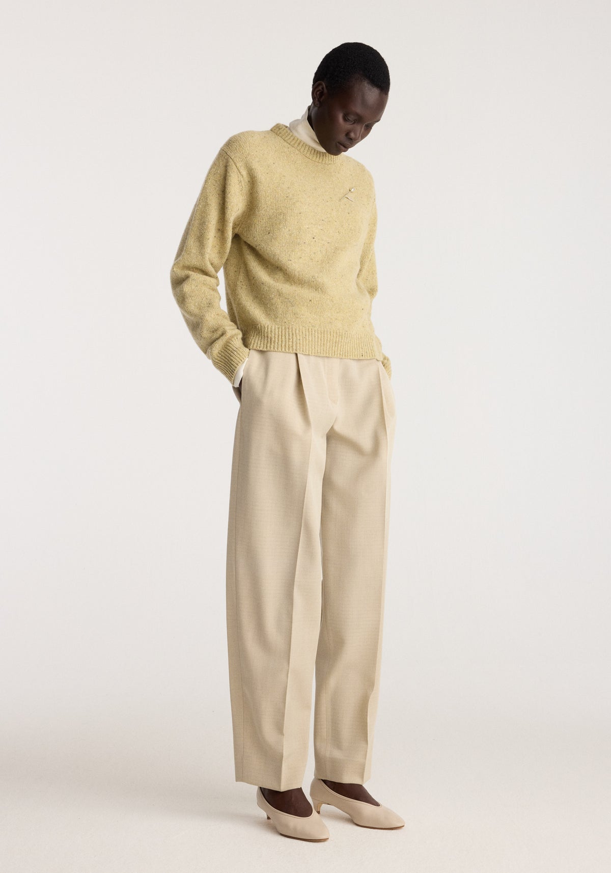 Fitted mouliné crewneck | butter mouliné worn with wide leg trousers and loafers in a minimalist studio setting