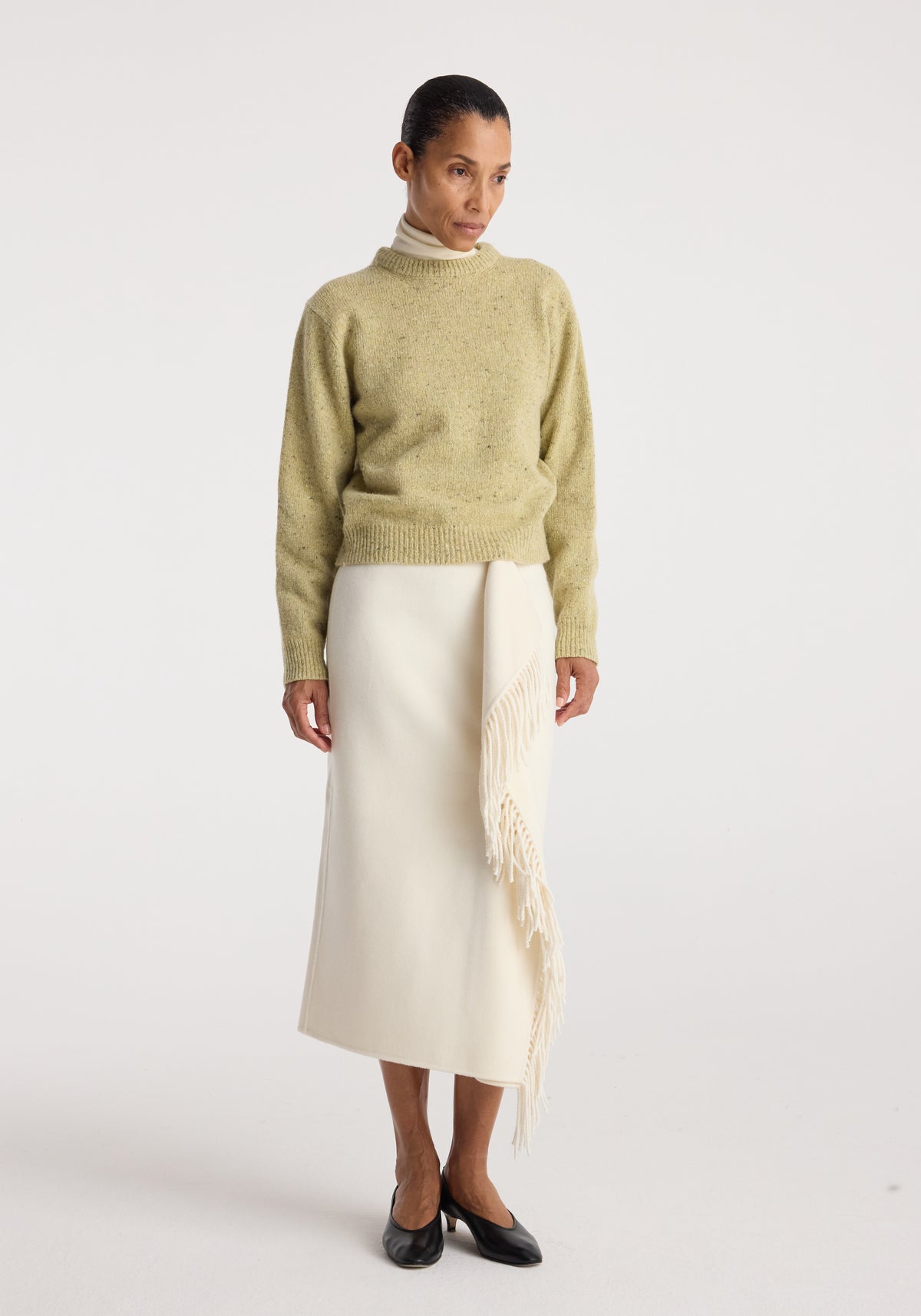 Fitted mouliné crewneck | butter mouliné worn with an ivory fringed midi skirt and black flats on a model in a studio setting