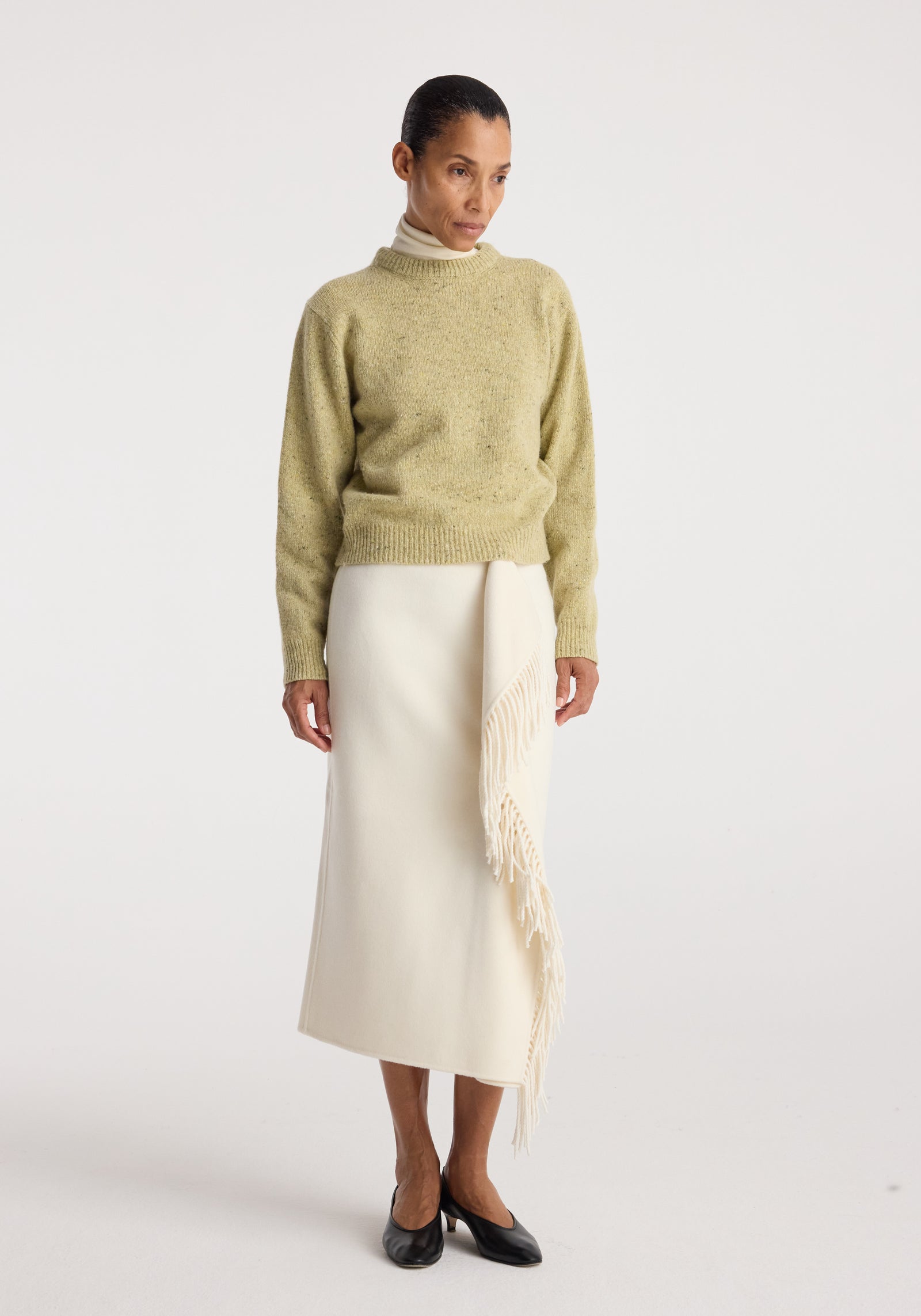 Fitted mouliné crewneck | butter mouliné worn with an ivory fringed midi skirt and black flats on a model in a studio setting