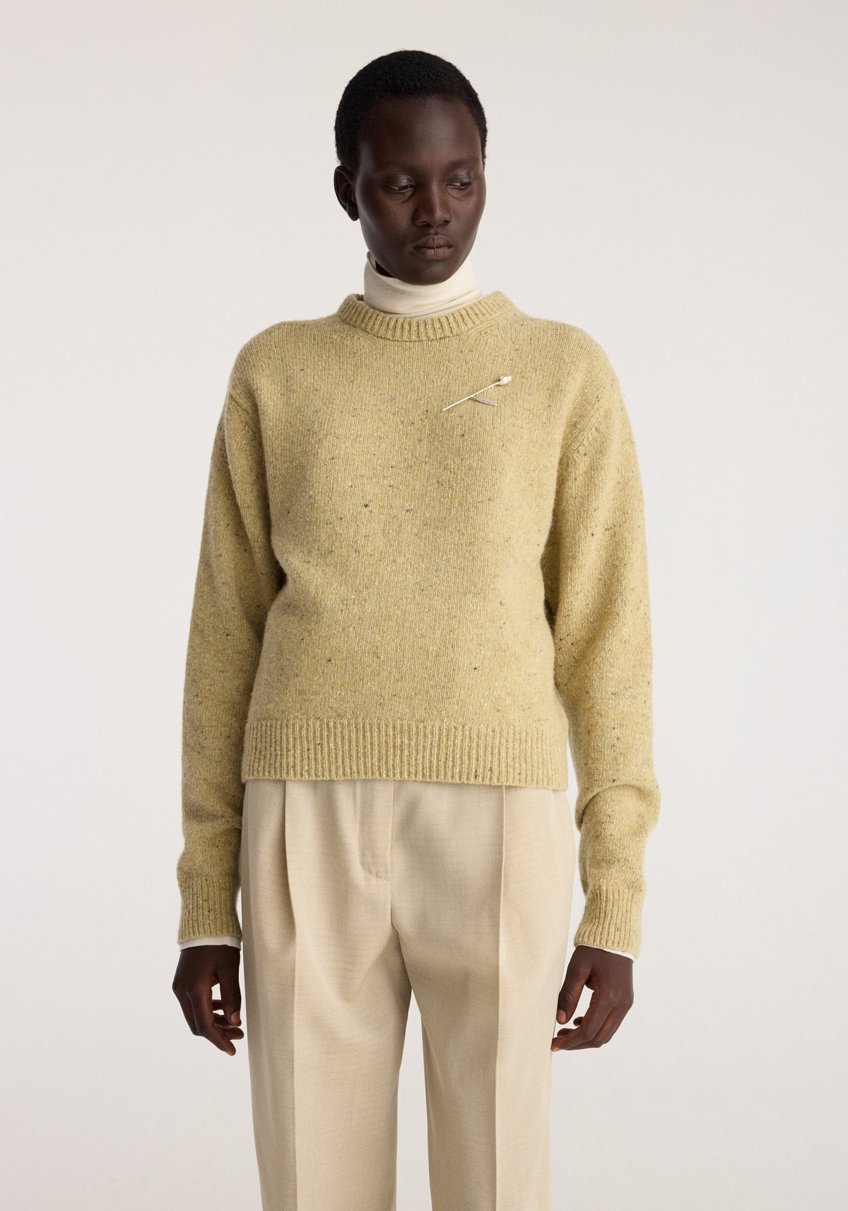 Fitted mouliné crewneck | butter mouliné worn by a model in a butter yellow knit with ribbed trim and relaxed sleeves over cream trousers