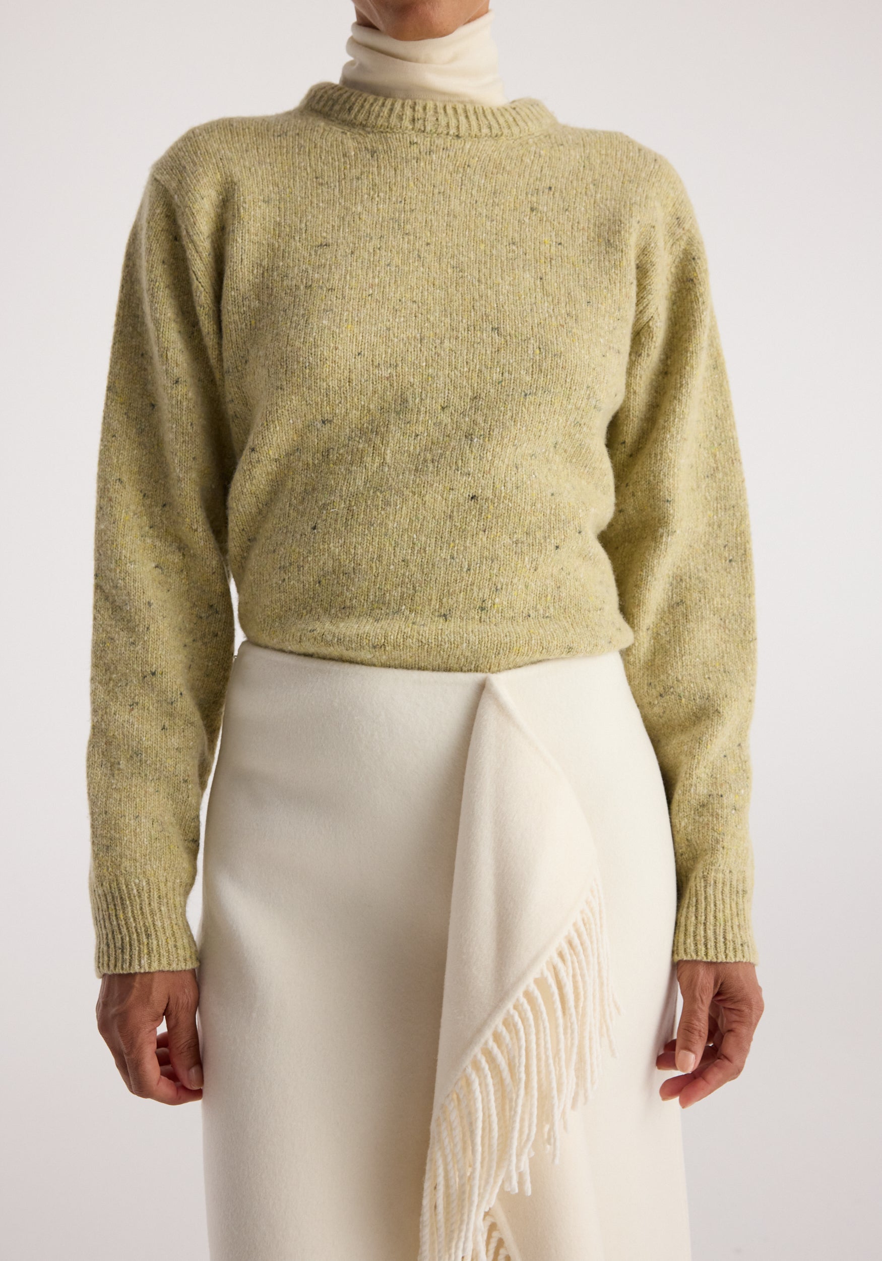 Fitted mouliné crewneck | butter mouliné worn with an ivory skirt and draped fringed scarf in a neutral studio setting