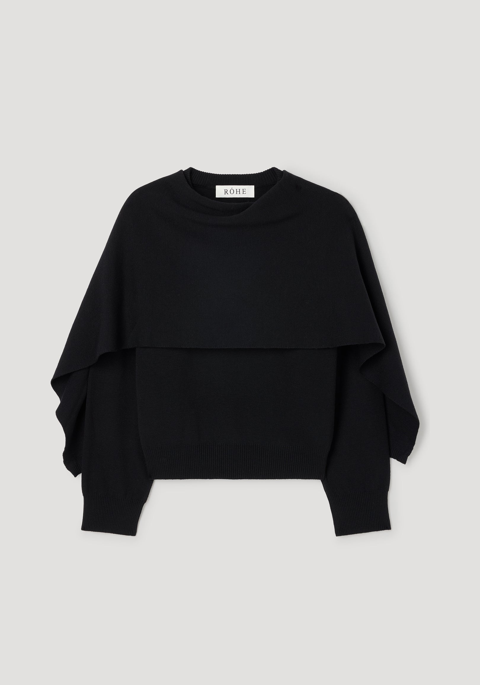 Cape jumper | black knitted sweater with a layered design and long sleeves, featuring a crew neckline and ribbed cuffs and hem.