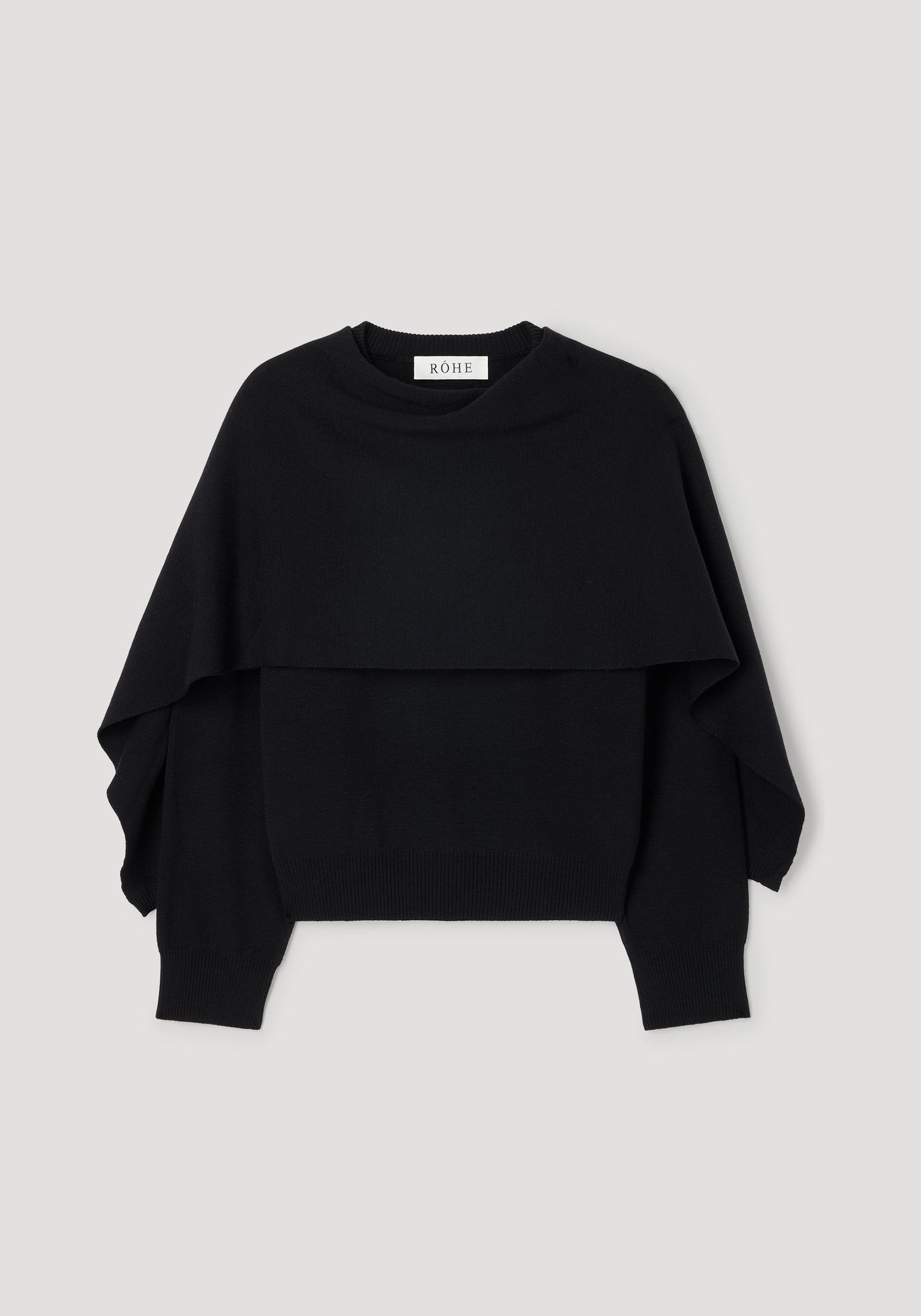 Cape jumper | black knitted sweater with a layered design and long sleeves, featuring a crew neckline and ribbed cuffs and hem.