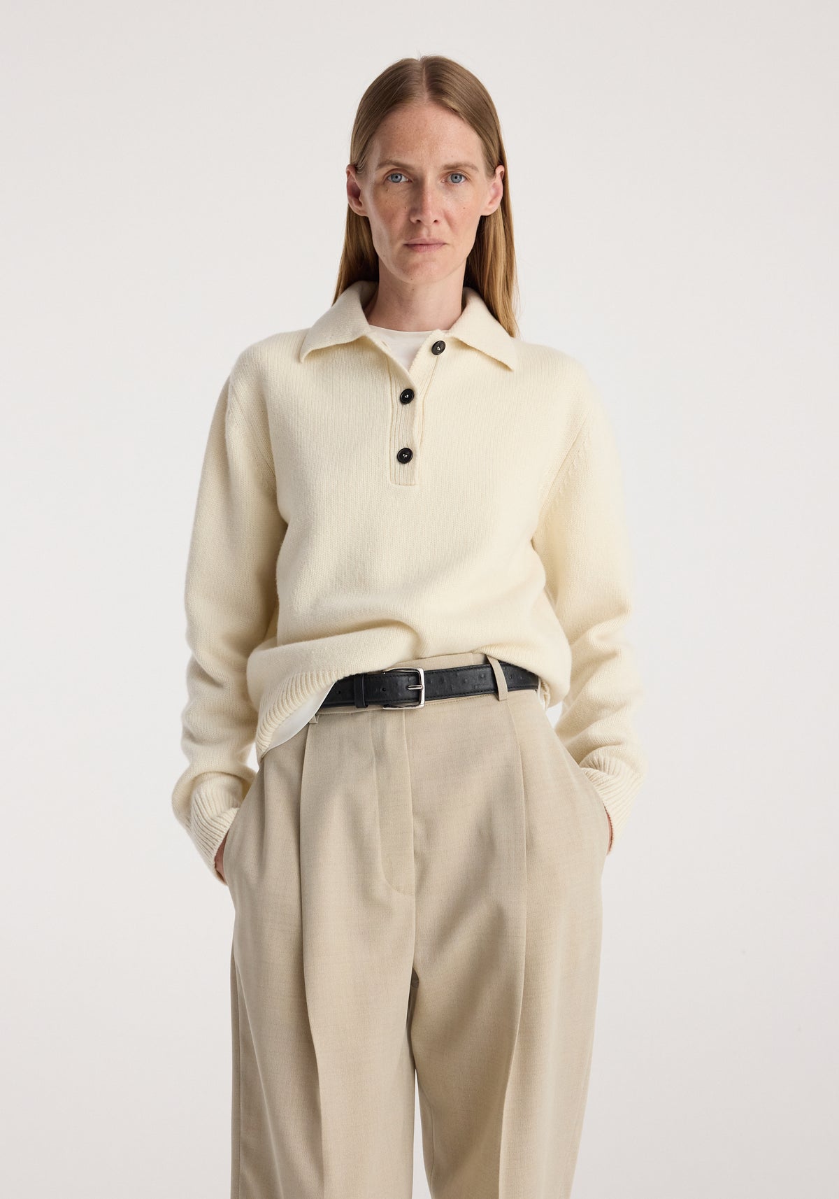 Wool-cashmere polo | cream worn by a woman with tailored beige trousers and a black belt against a neutral background