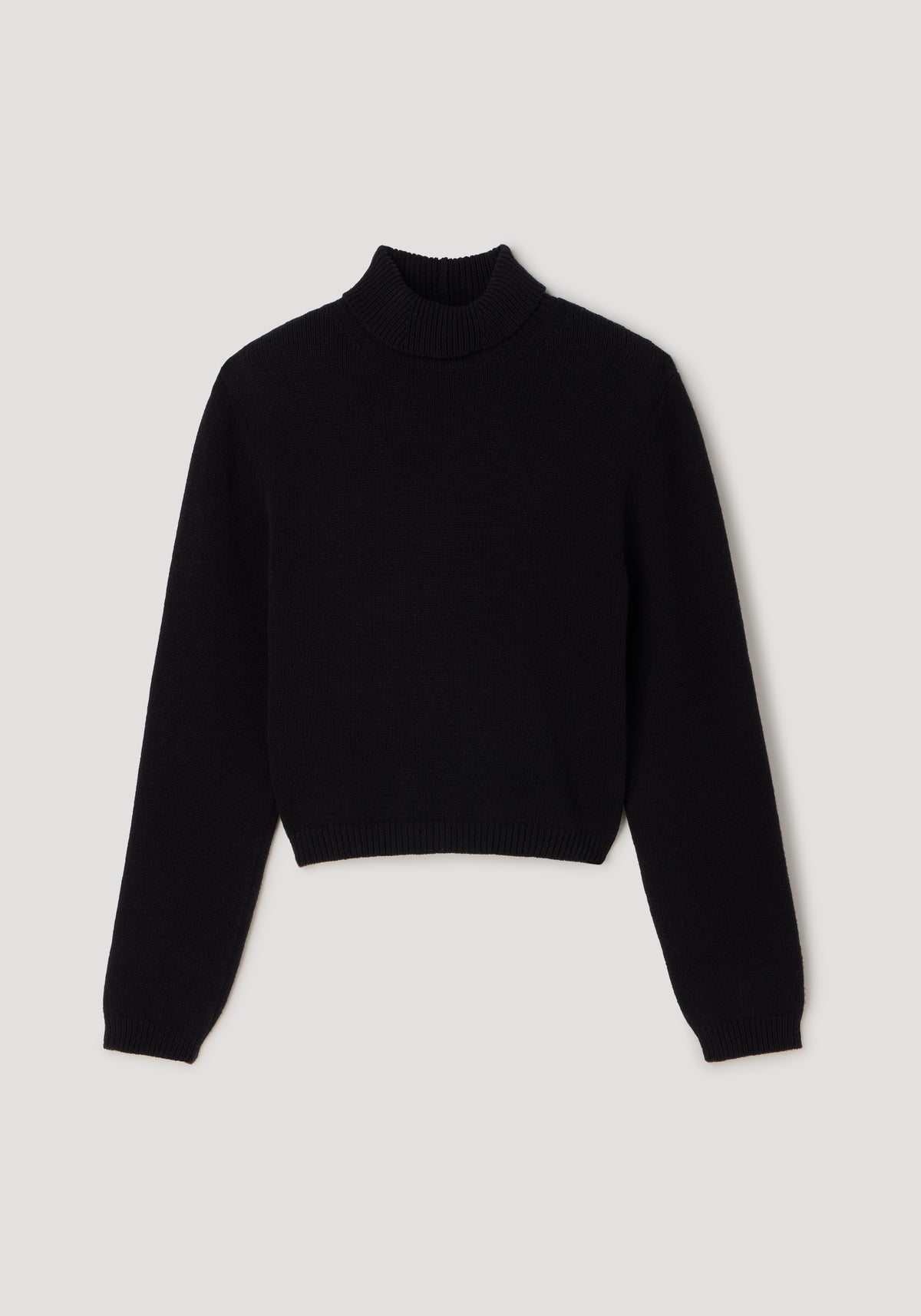 Black knitted turtleneck sweater with long sleeves and a slightly cropped fit, featuring the design named Statement shoulder turtleneck | black.