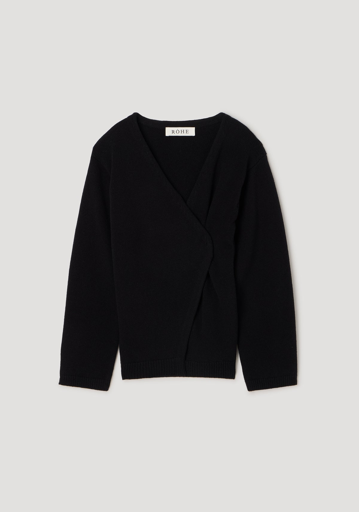 Black knitted off-shoulder wrap cardigan with long sleeves, featuring a soft texture and a wrap-style front closure, perfect for layering and stylish comfort.