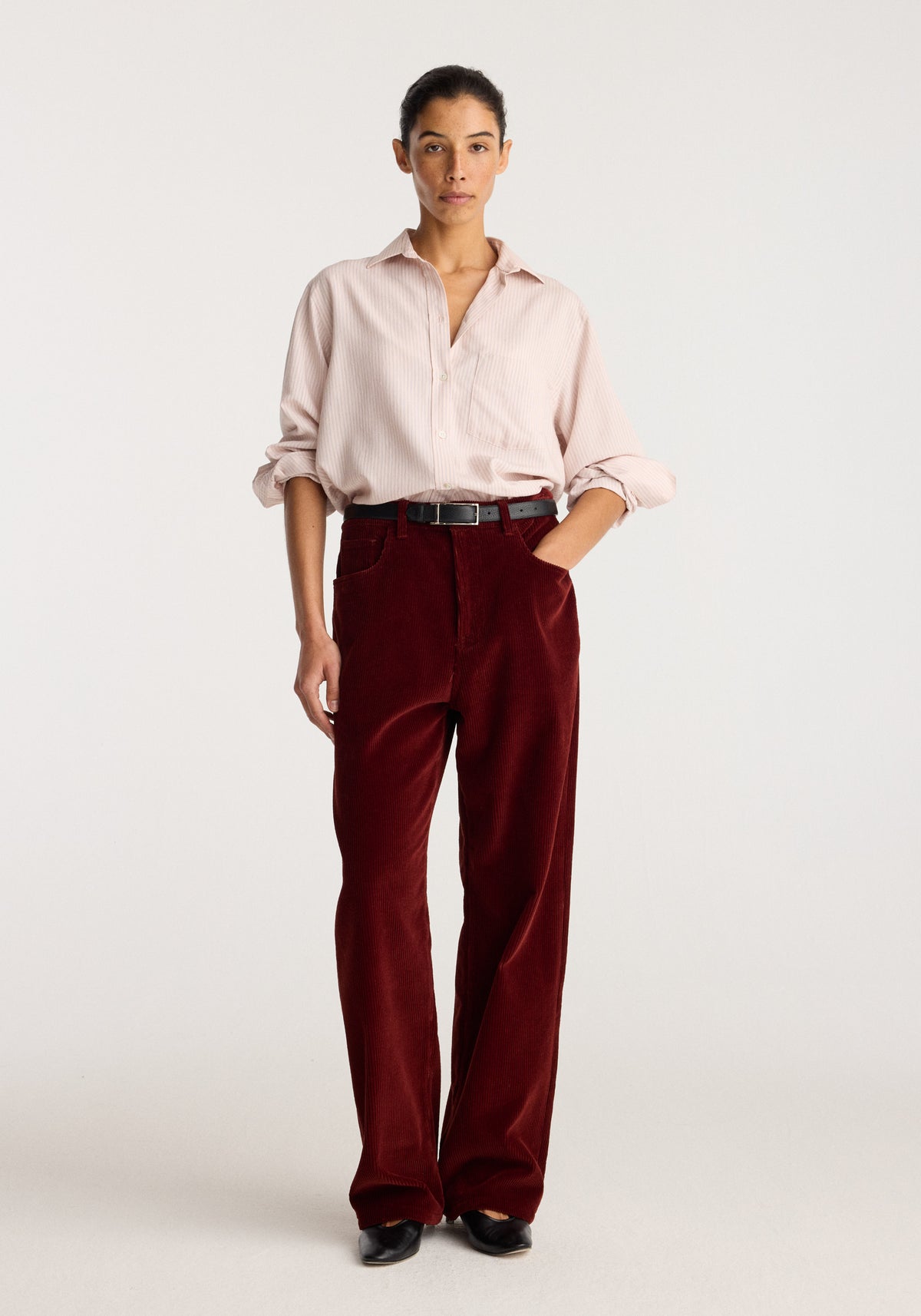 Bruun - Signature baggy corduroy trousers | wine worn by a model with a pale pink shirt and black shoes against a light background
