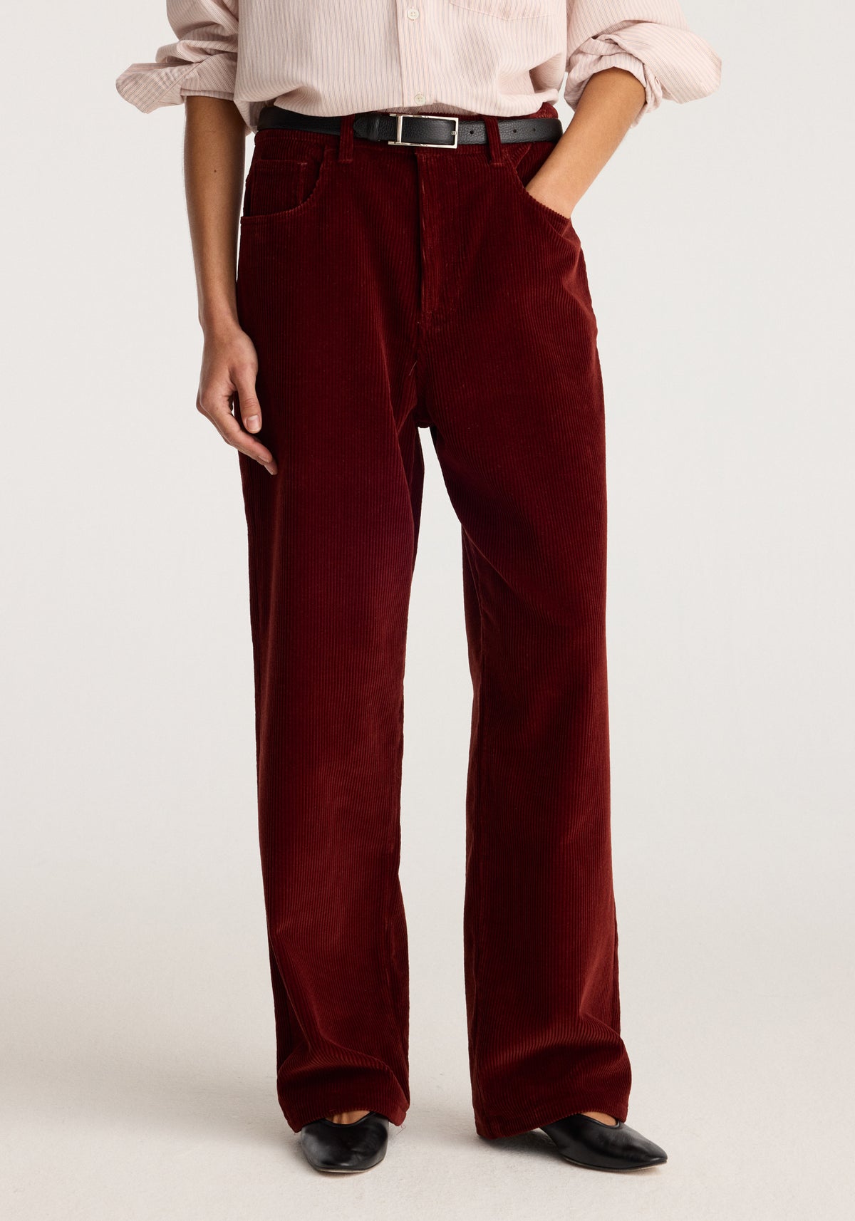 Bruun - Signature baggy corduroy trousers | wine shown on a model with wide legs, belt loops, front pockets, and black shoes.