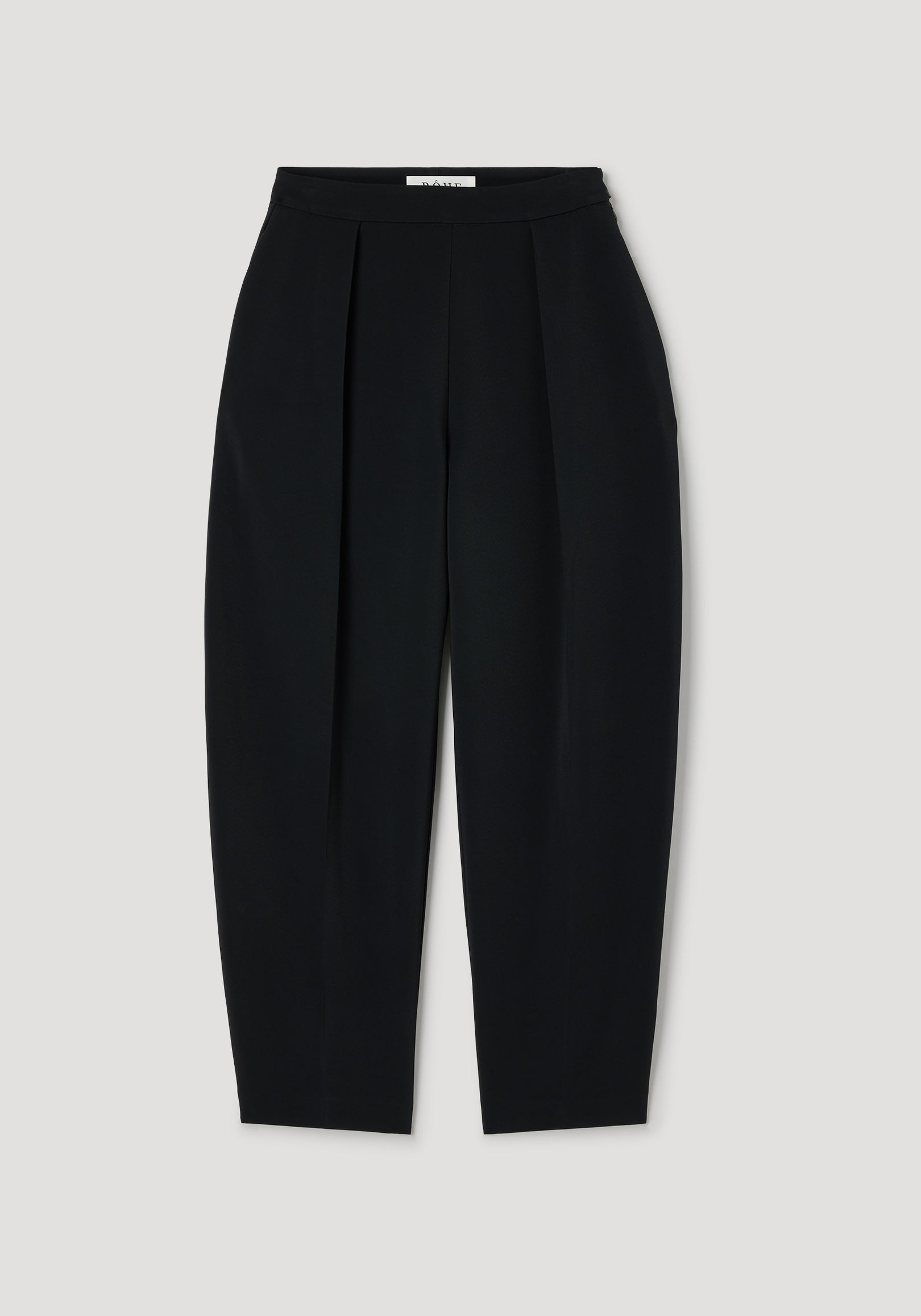 Puck - Sculptural tailored trousers | black, black high-waisted trousers with sculptural pleats, a tapered leg, and a clean tailored finish on a neutral background