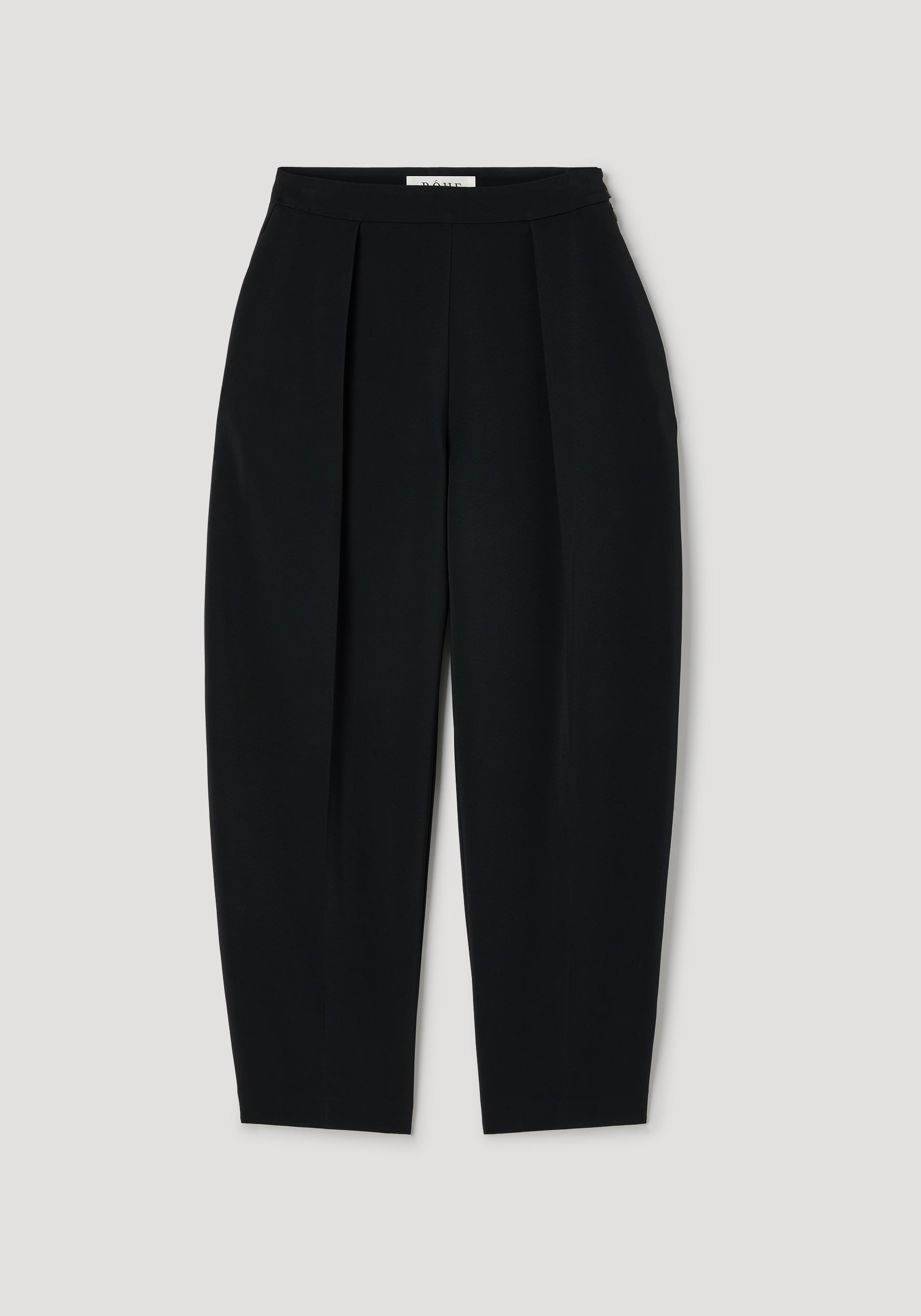 Puck - Sculptural tailored trousers | black, black high-waisted trousers with sculptural pleats, a tapered leg, and a clean tailored finish on a neutral background