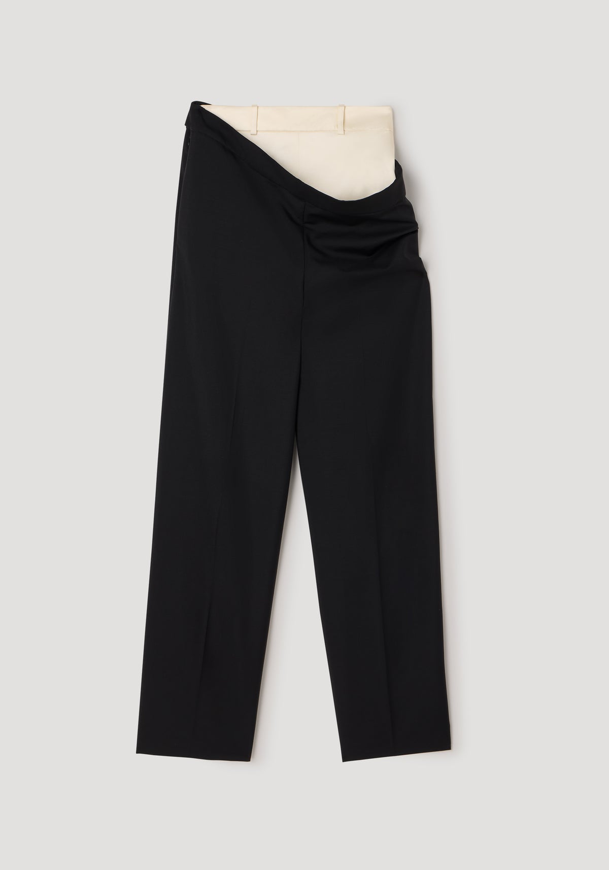 Double waistband trousers | black featuring a unique design with an overlapping black outer waistband and a contrasting beige inner waistband on a neutral background.