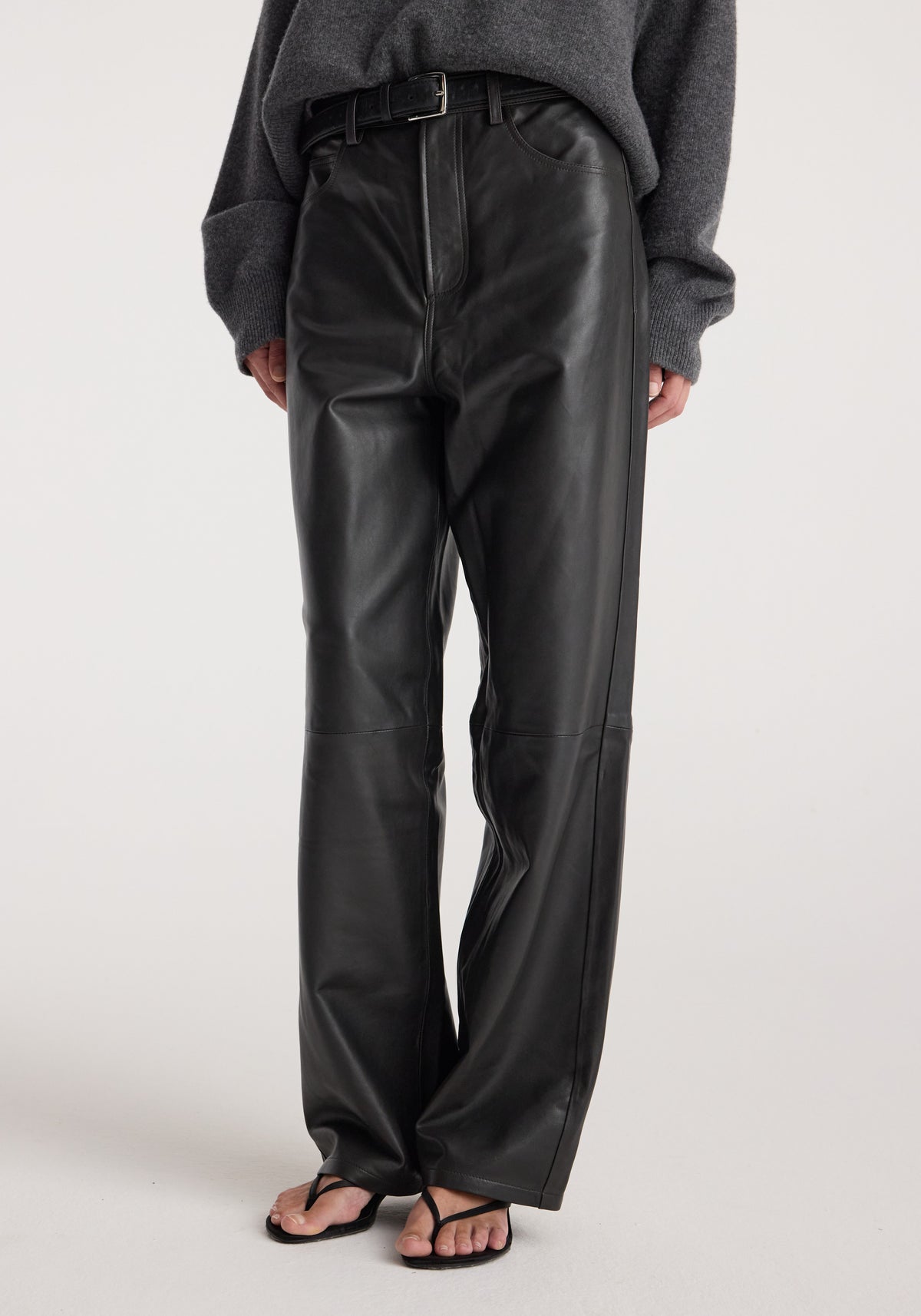 Bruun - Leather baggy trousers | anthracite worn with a dark oversized sweater and black sandals, showcasing the relaxed fit and full-length design