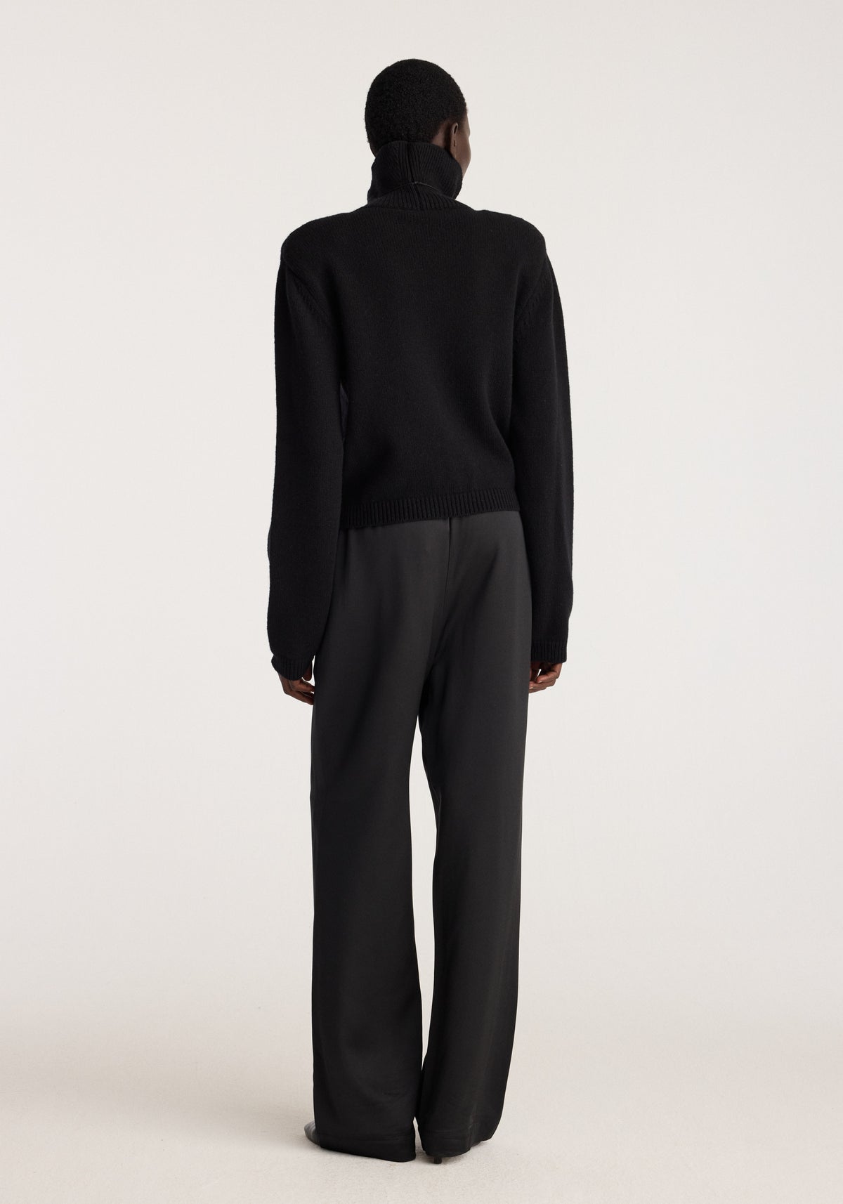 Relaxed fit satin trousers | black shown from the back on a model, featuring wide straight legs and a smooth drape