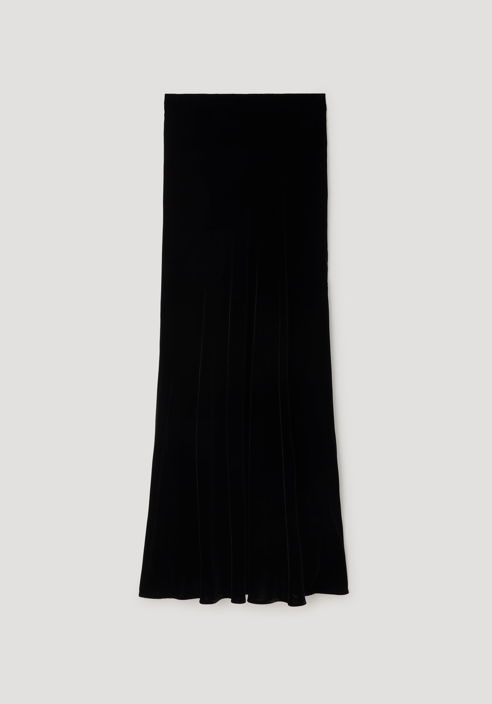 Fluid velvet skirt | black photographed flat on a neutral background, showcasing its long, sleek silhouette and smooth velvet texture.