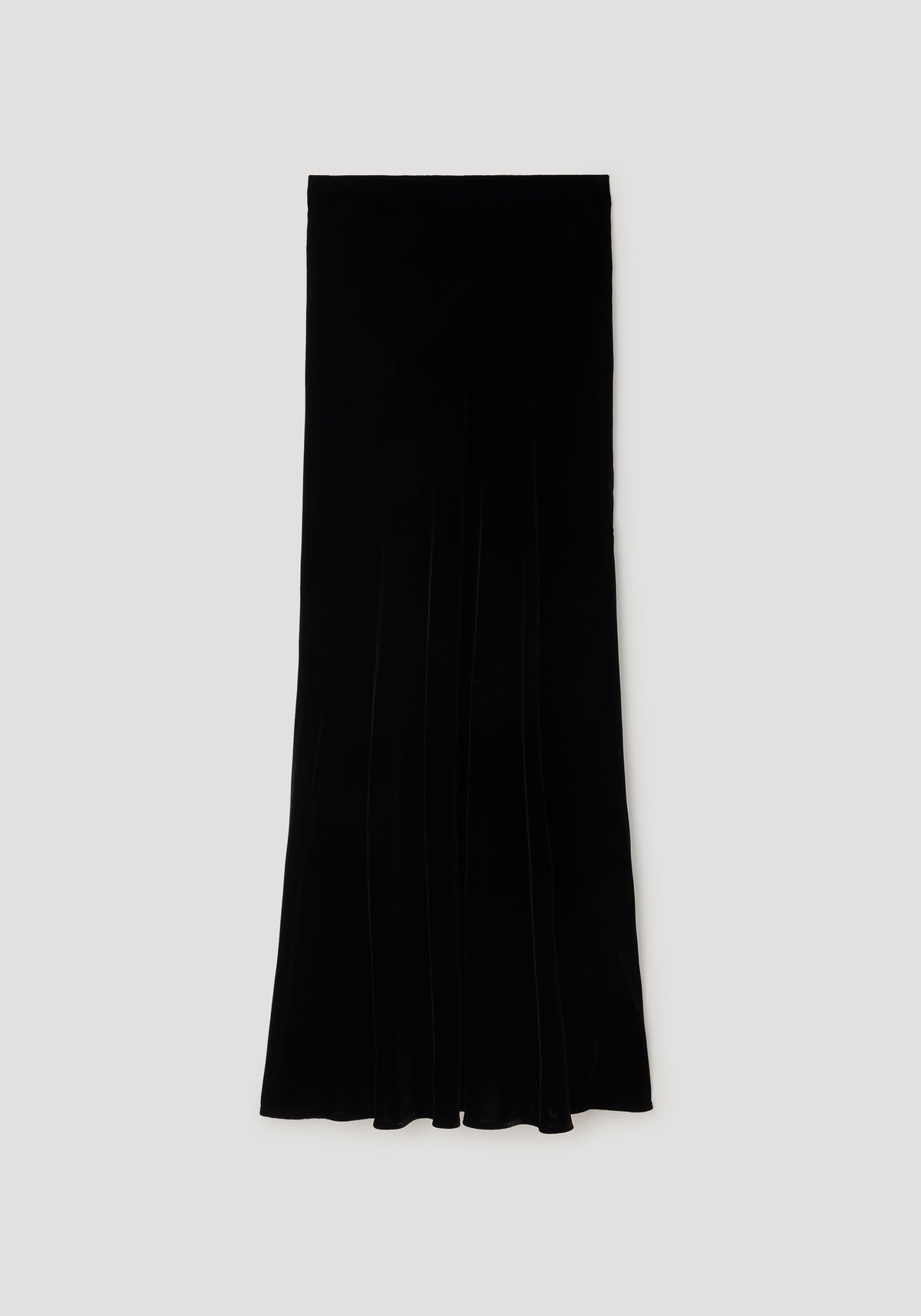 Fluid velvet skirt | black photographed flat on a neutral background, showcasing its long, sleek silhouette and smooth velvet texture.