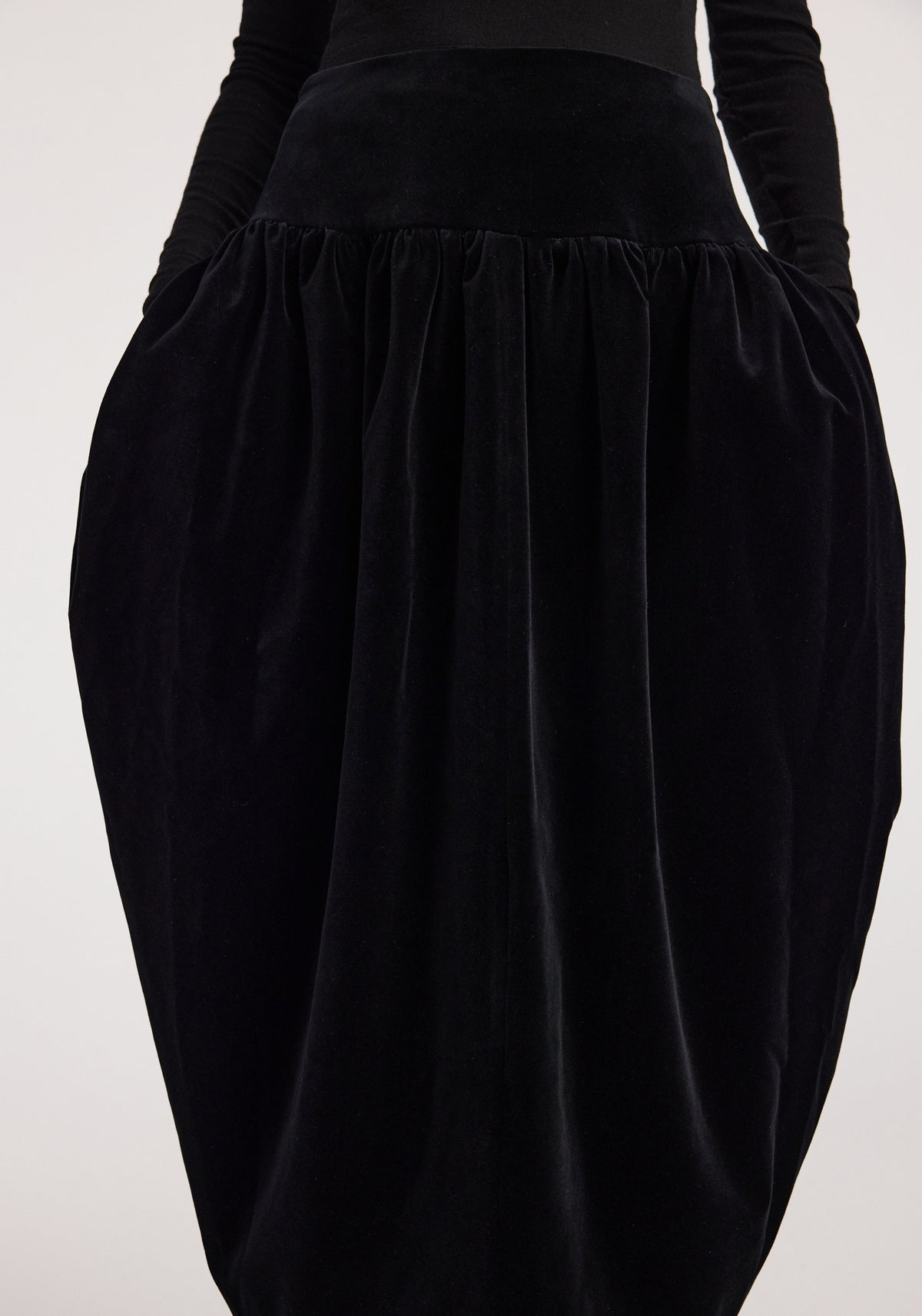 Sculptural volume velvet skirt | black with a high waist, gathered pleats, and dramatic rounded silhouette styled with a fitted black top
