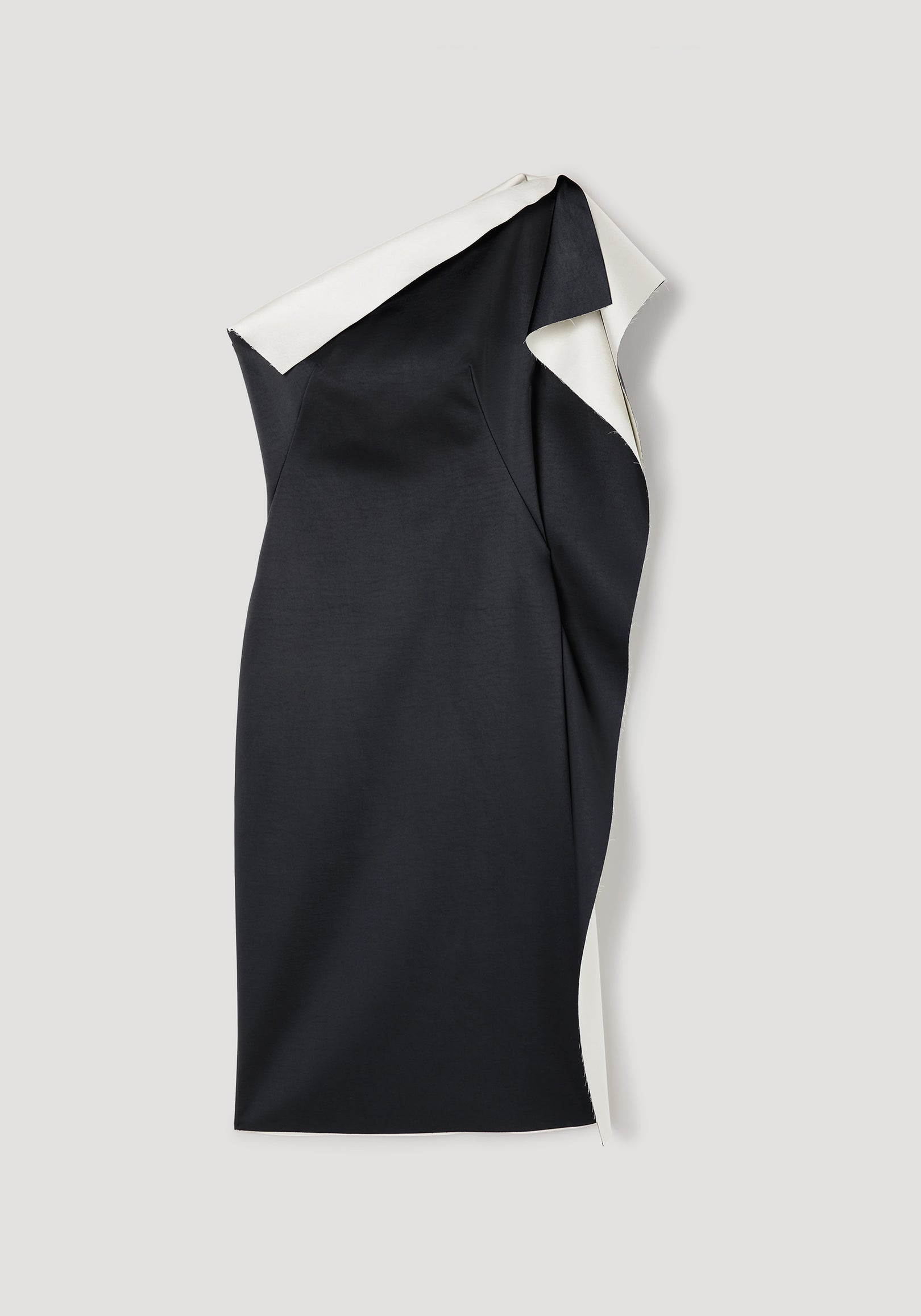 Sleek black and white sculptural double-satin off-shoulder dress | black/white laid flat, showcasing its asymmetrical design and elegant draping.