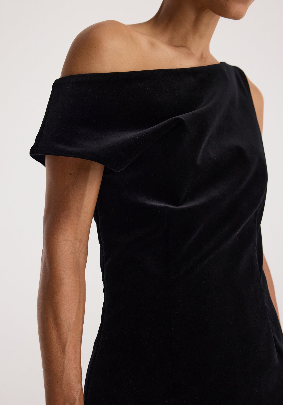 Sculptural off-shoulder velvet gown | black shown on a model with a draped neckline and sculpted silhouette