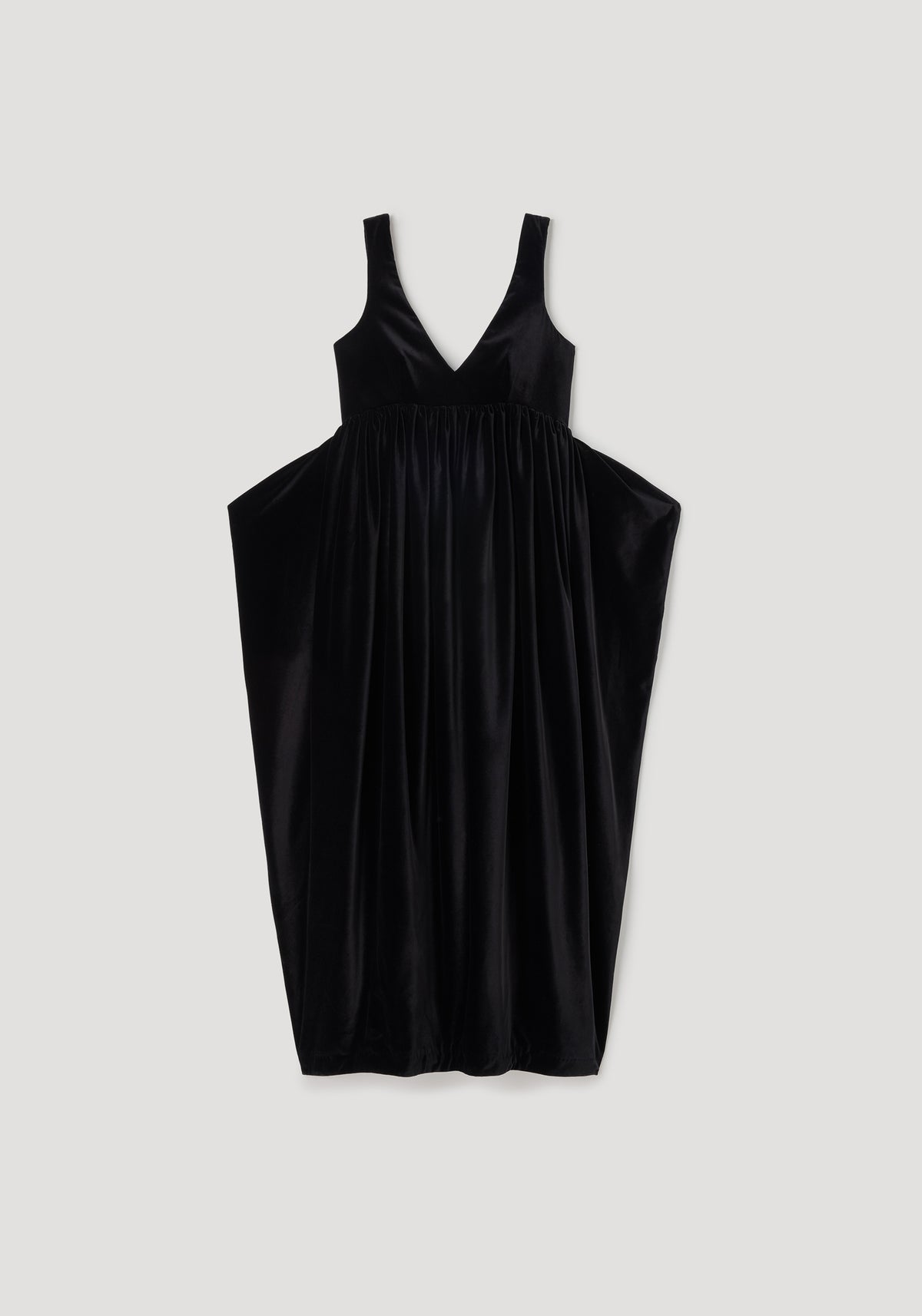 Sculptural volume velvet dress | black, sleeveless V neck design with gathered waist and voluminous flowing skirt against a light background