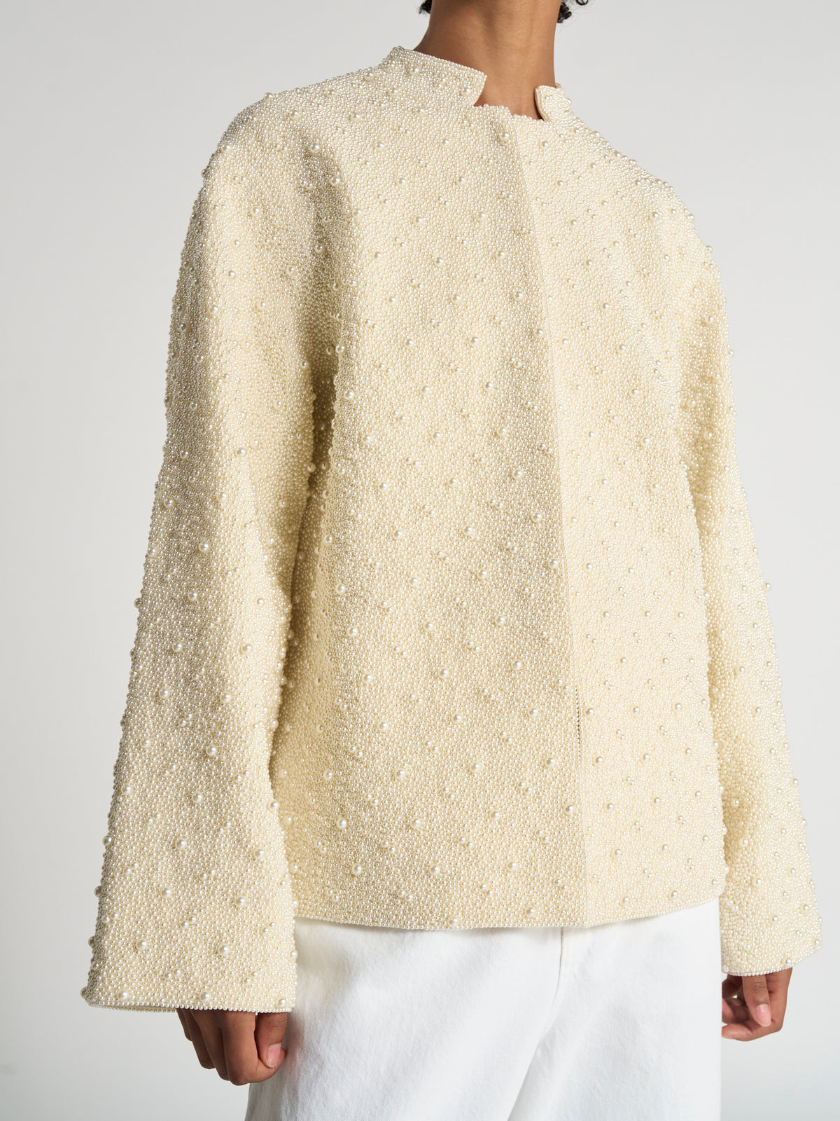 Hand-beaded pearl pankou jacket | pearl in cream with textured pearl beading, a high neckline, long sleeves, and a relaxed fit, styled with white trousers