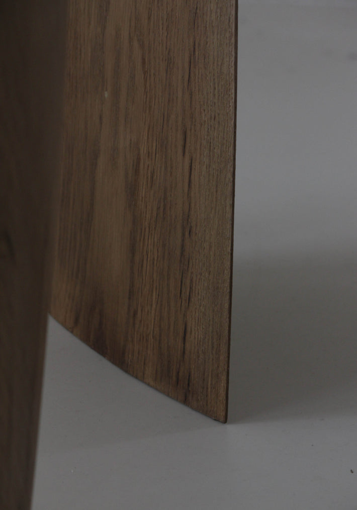 Sculpted Stool | 4673: Close-up of a handcrafted oak stool with visible wood grain and a slightly beveled edge, standing on a light floor.