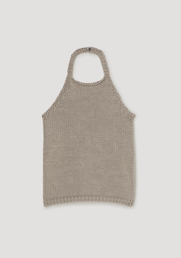 Chunky knit halter top | stone features a sleeveless, beige halter-style with a button closure at the neck, crafted in chunky cotton for a relaxed fit.