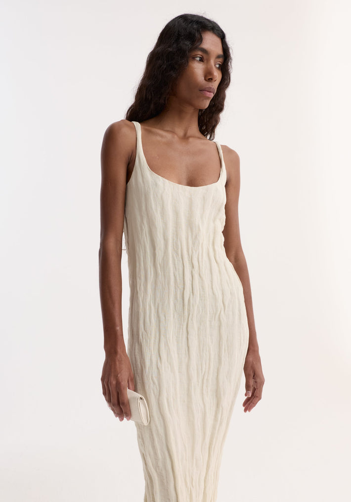 Model in cream Textured Square Neck Dress, sleeveless with scooped neck, holding matching clutch, showcasing crinkled fabric with metallic yarn texture.