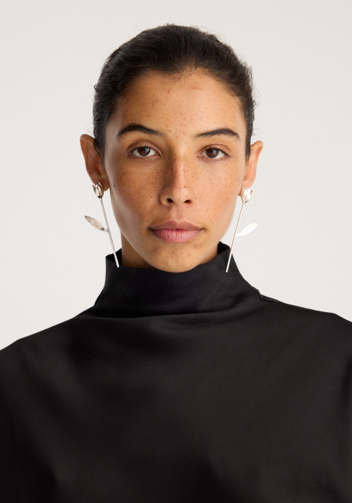 Tulip silver earrings (pair) | silver shown worn by a model with delicate silver tulip earrings visible against a light background