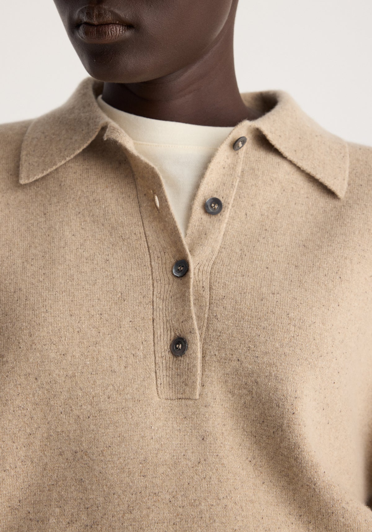 Wool cashmere polo | stone melange shown in close view with a soft beige knit collar three button placket and cream undershirt underneath